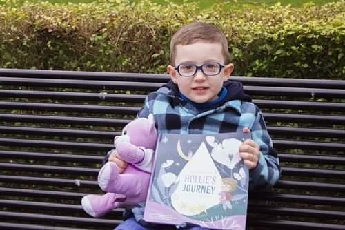 Kai with a copy of Hollie's Journey