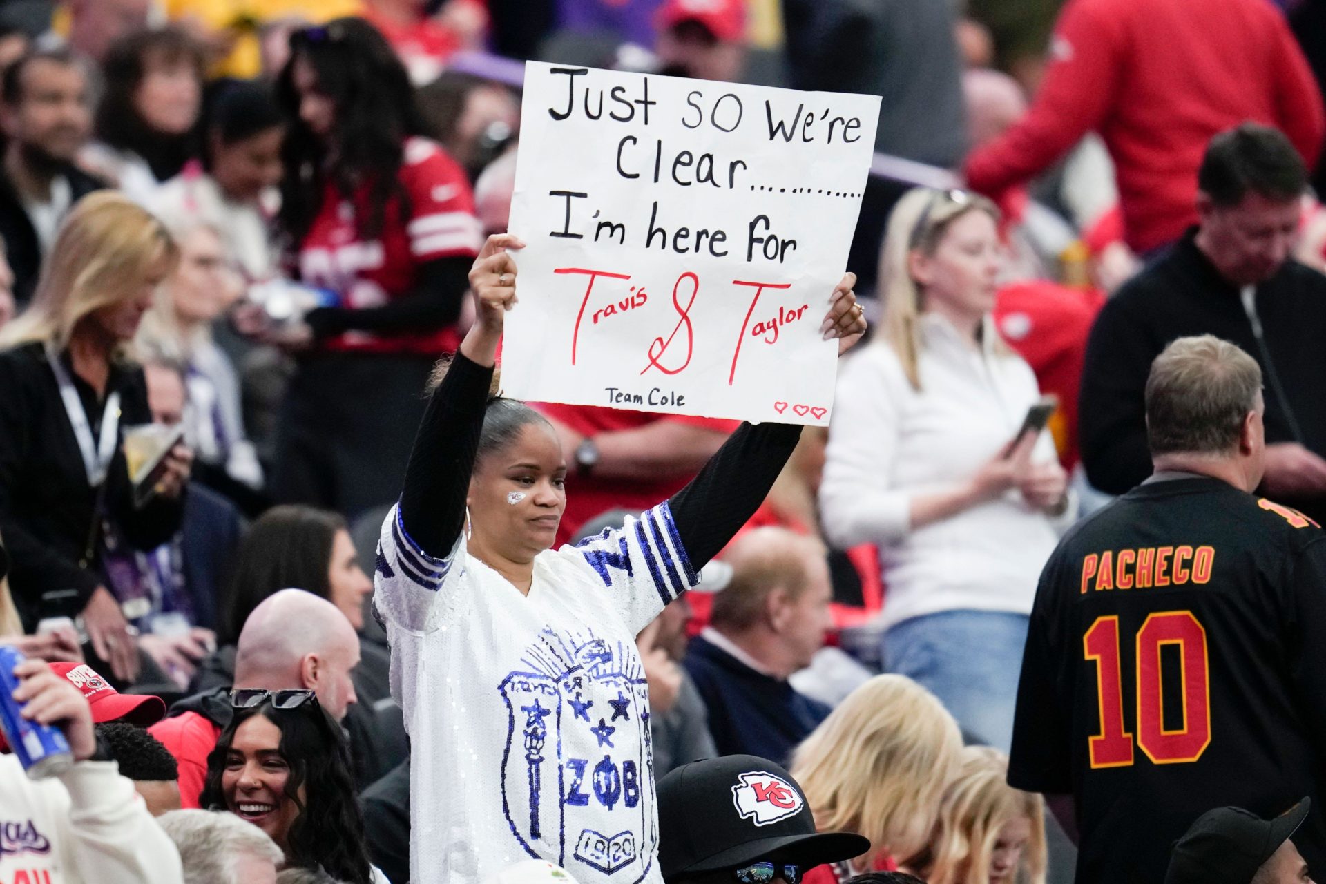 A fan holds a sign for Taylor Swift and Travis Kelce before the Super Bowl in Las Vegas, 11-2-24. 
