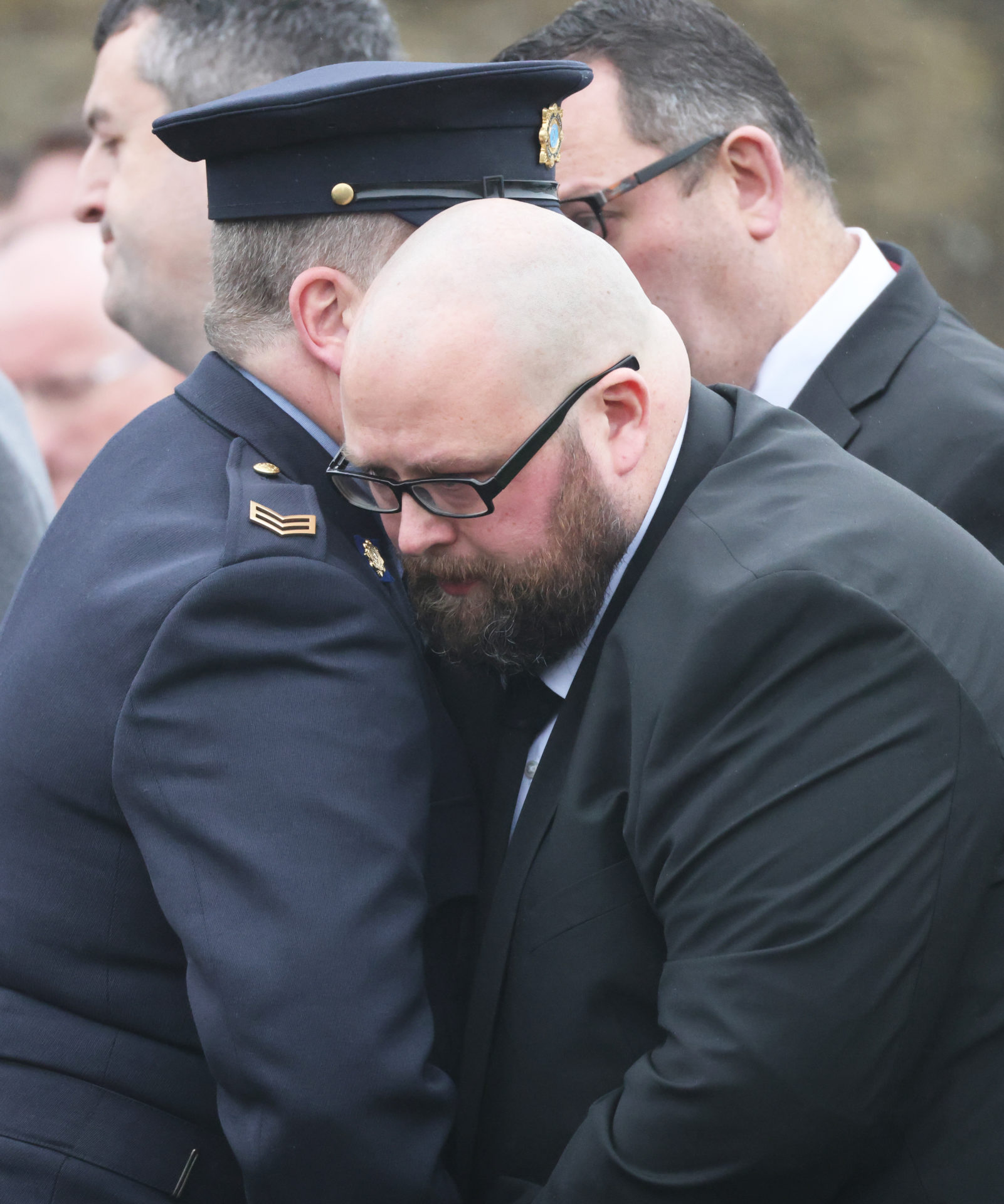 James Healy is comforted by a Garda at the funeral of his son Matthew Healy in the Church of the Immaculate Conception in Cork, 14-2-24.