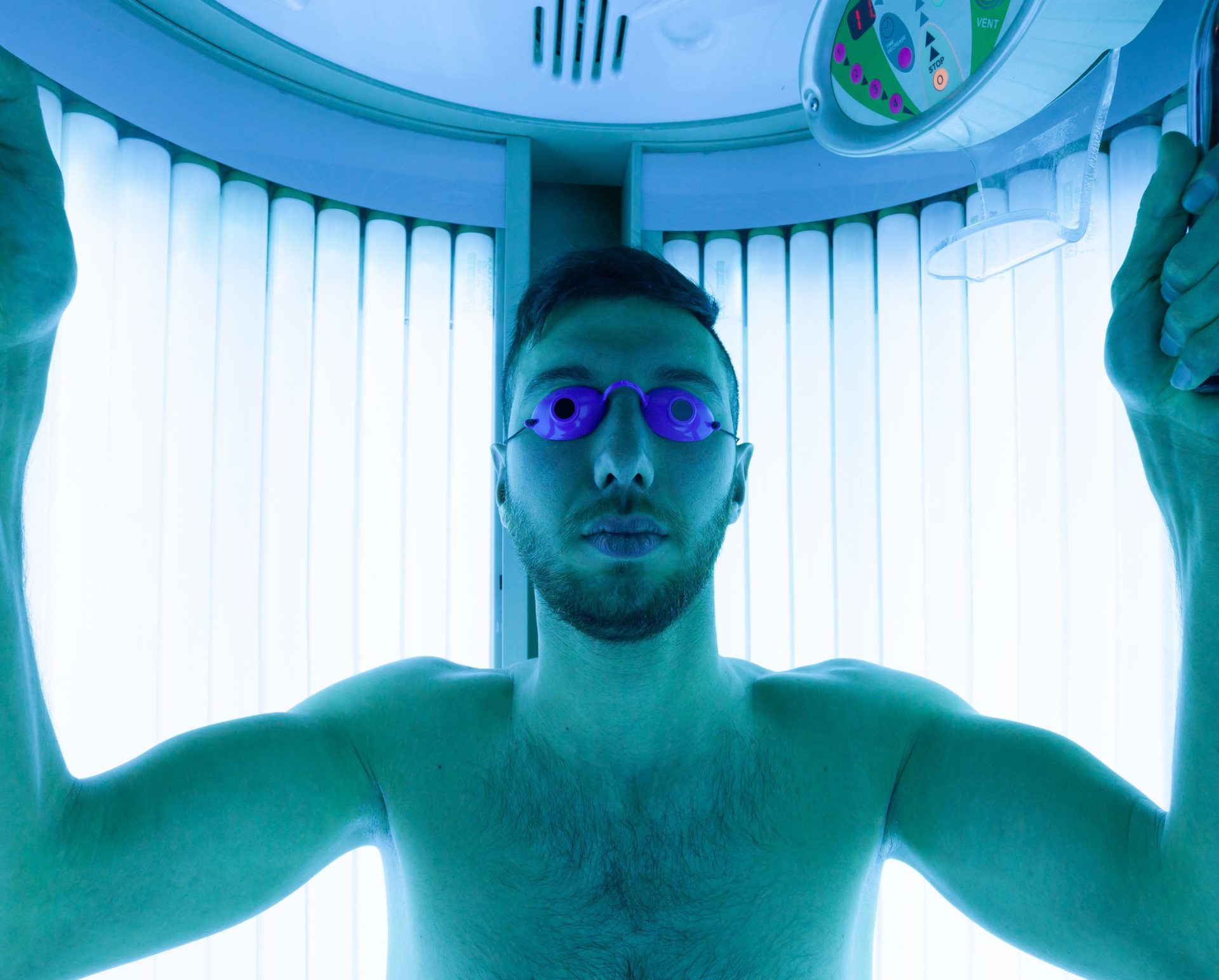 A man using a tanning bed.