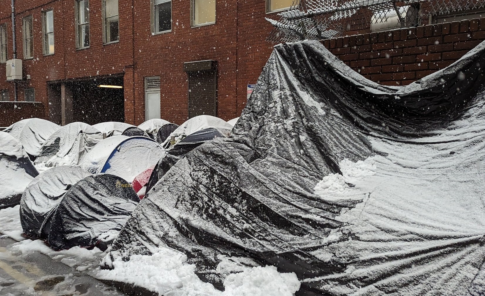 Tents are seen under snow outside the International Protection Office in Dublin city, 1-3-24.