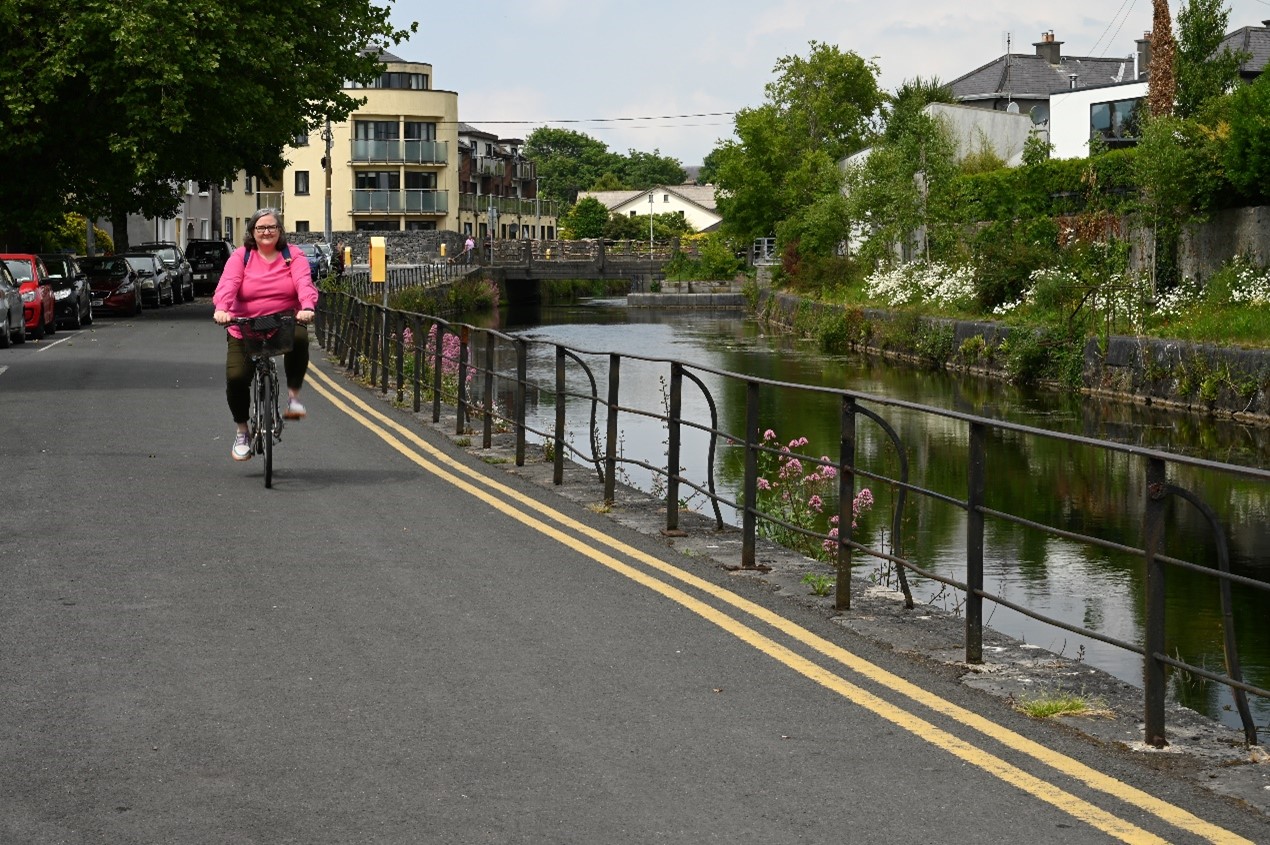 A woman cycling in Galway.