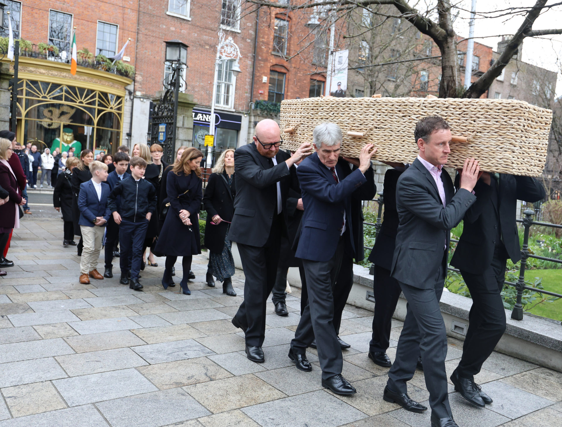 Family and loved ones follow Charlie Bird's coffin into the Mansion House ahead of his funeral service, 14-3-24