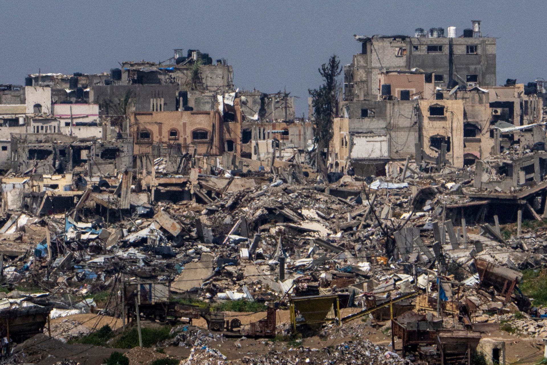 Main image shows destroyed buildings inside the Gaza Strip, as seen from southern Israel
