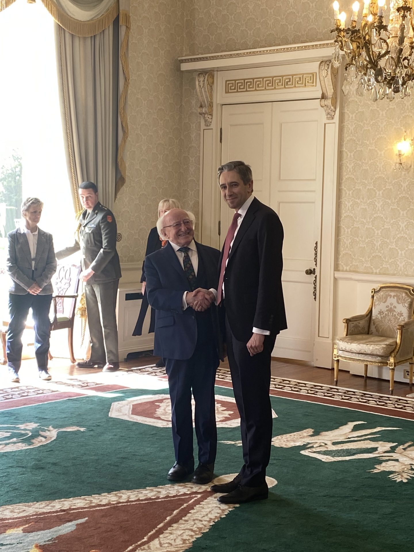 Simon Harris shakes President Michael D Higgins hand after his formal appointment as Taoiseach. 