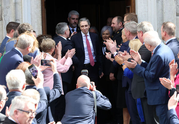 Incoming Taoiseach Simon Harris is congratulated by party colleagues and well-wishers as he leaves Leinster House to go to Áras an Uachtarain to get his seal of office