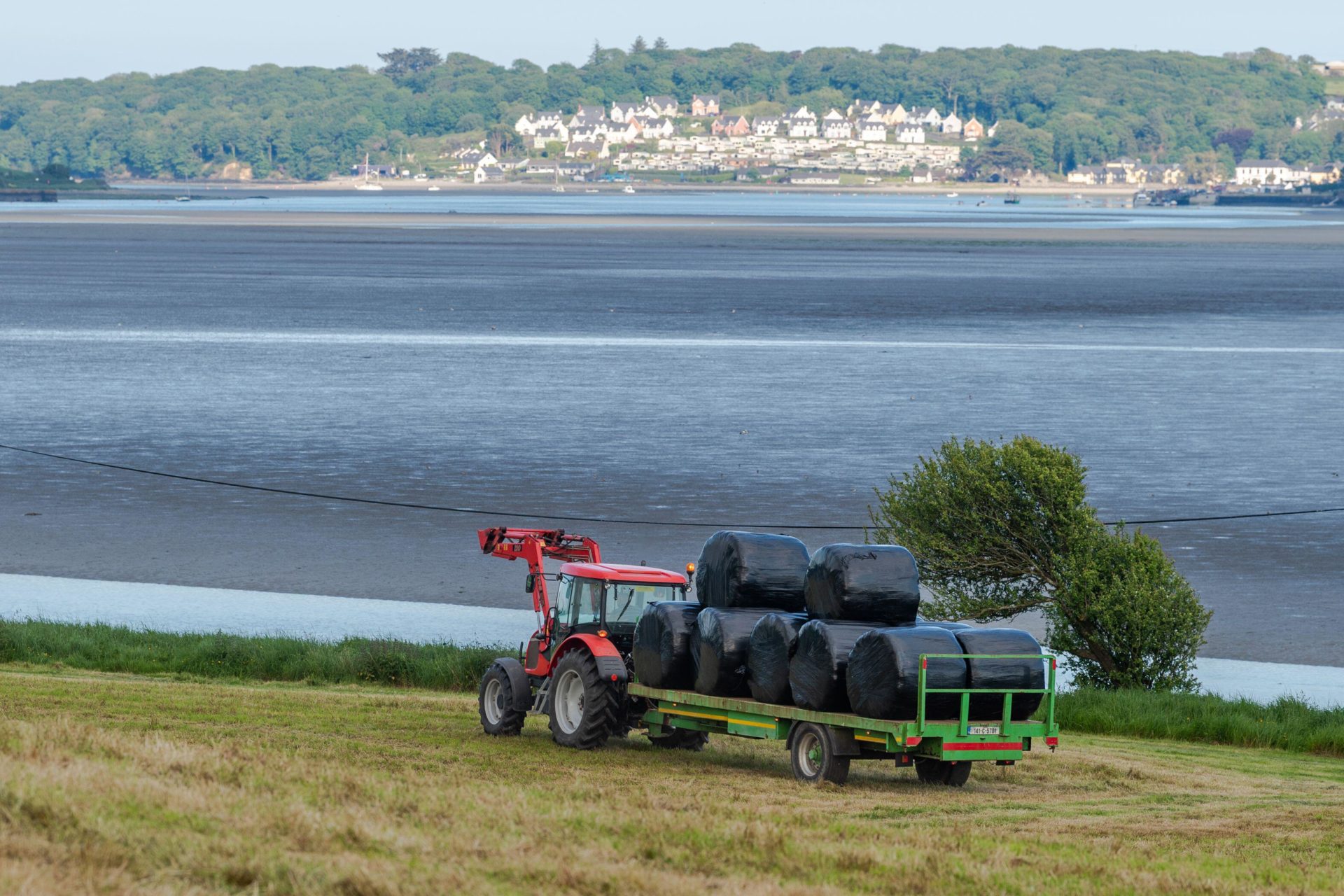 A farmer with bales of silage.