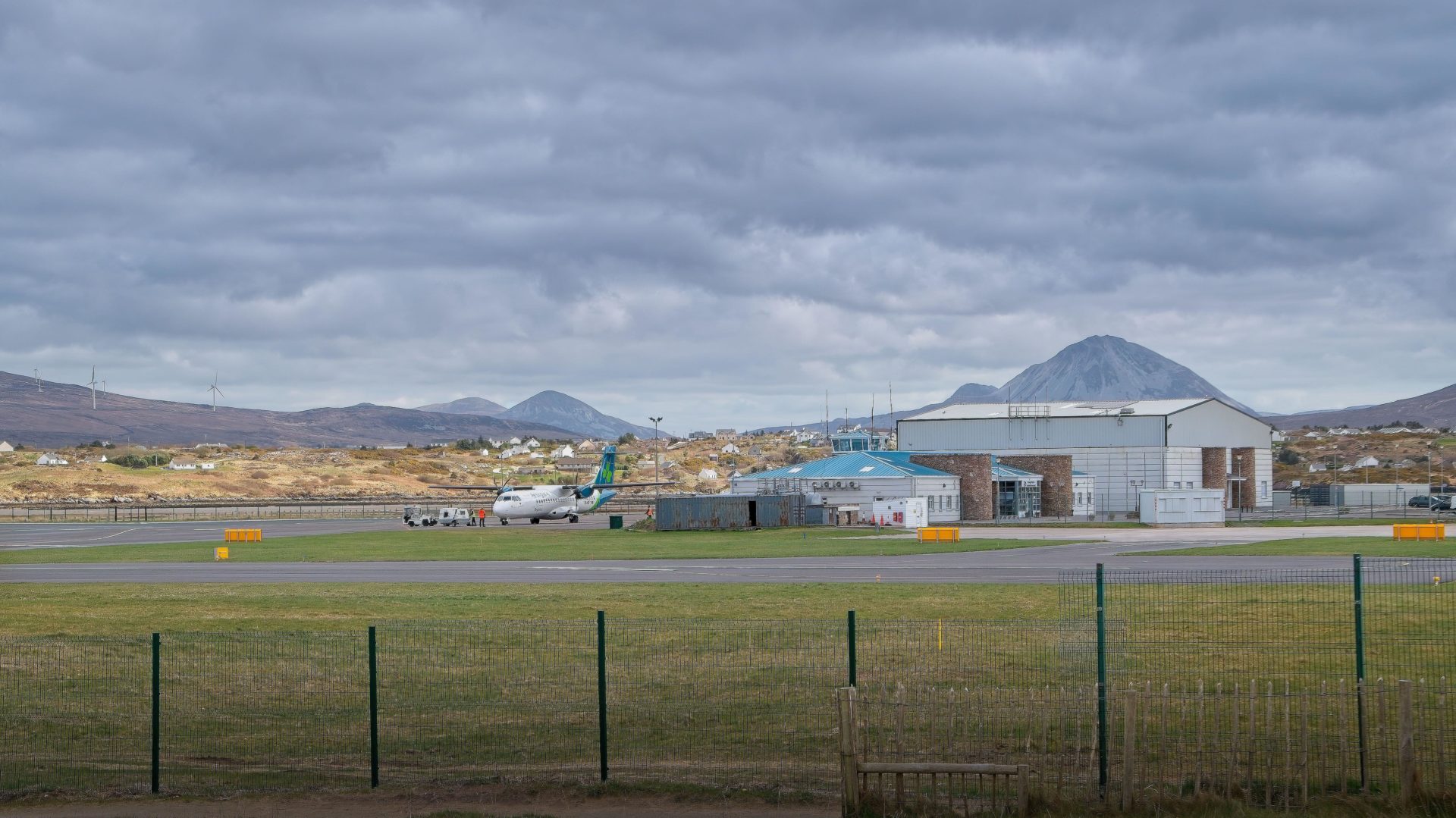 Carrickfinn airport County Donegal, airplane and buildings, mountains on background, Republic of Ireland
