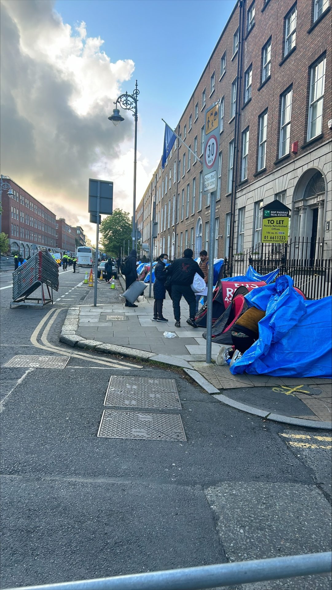 Officials and asylum seekers during an operation to remove tents outside the International Protection Office in Dublin, 1-5-24. 