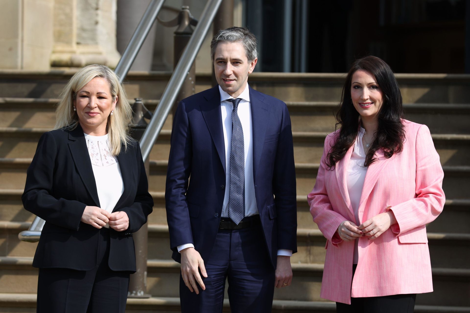 Taoiseach Simon Harris is greeted by Northern Ireland First Minister Michelle O'Neill and Deputy First Minister Emma Little-Pengelly outside Stormont Castle, 3-5-24.