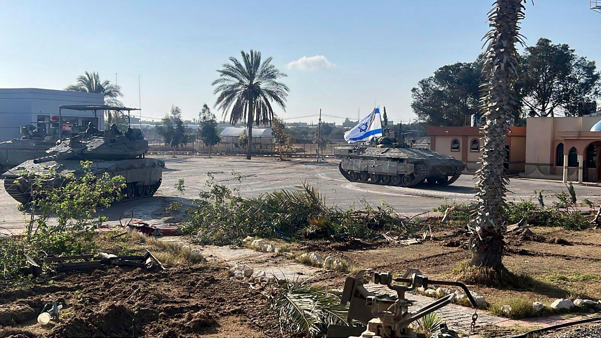 This photo provided by the Israel Defence Forces shows a tank with an Israel flag entering the Gazan side of the Rafah border crossing, 7-5-24. 
