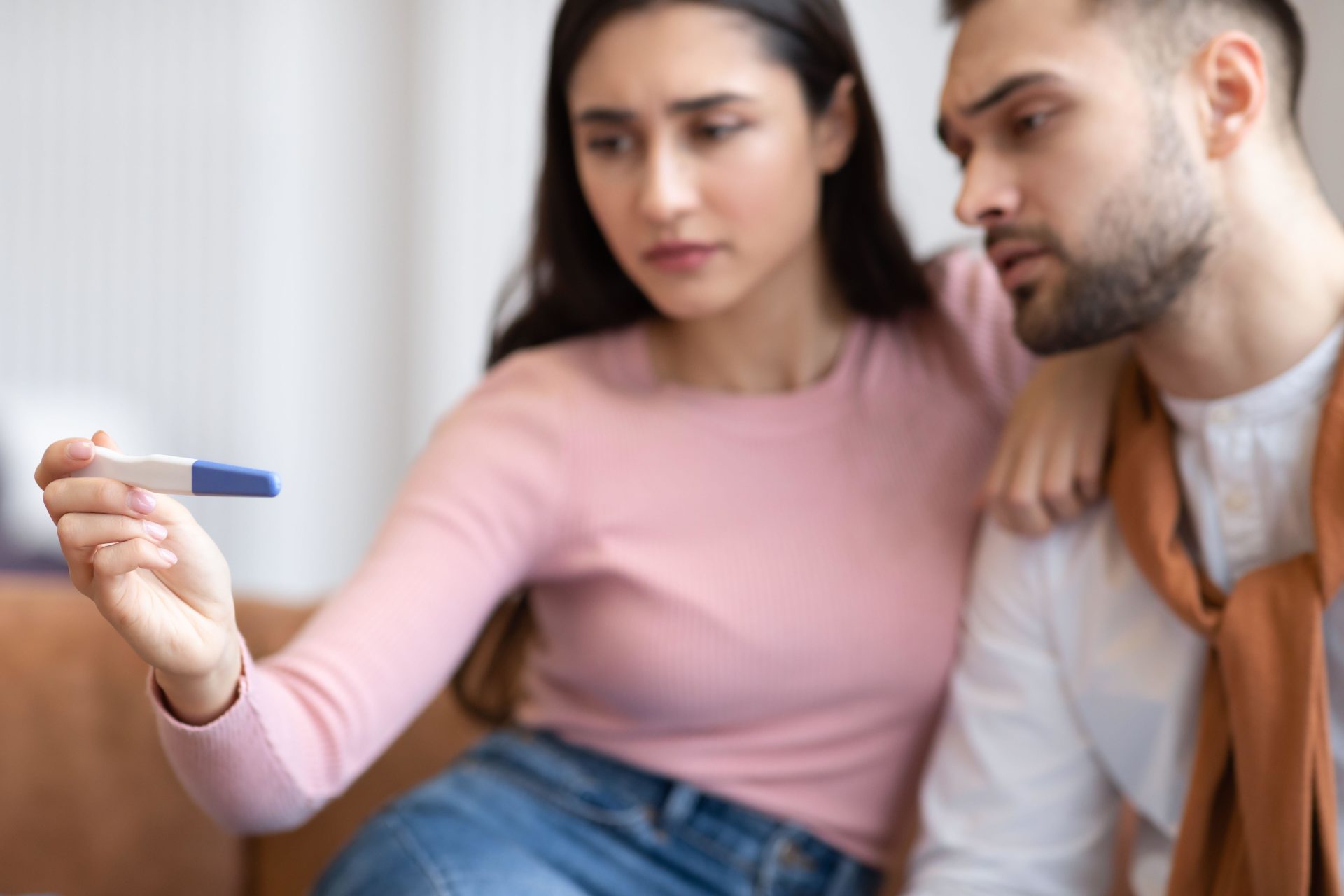 A couple looking at a pregnancy test.