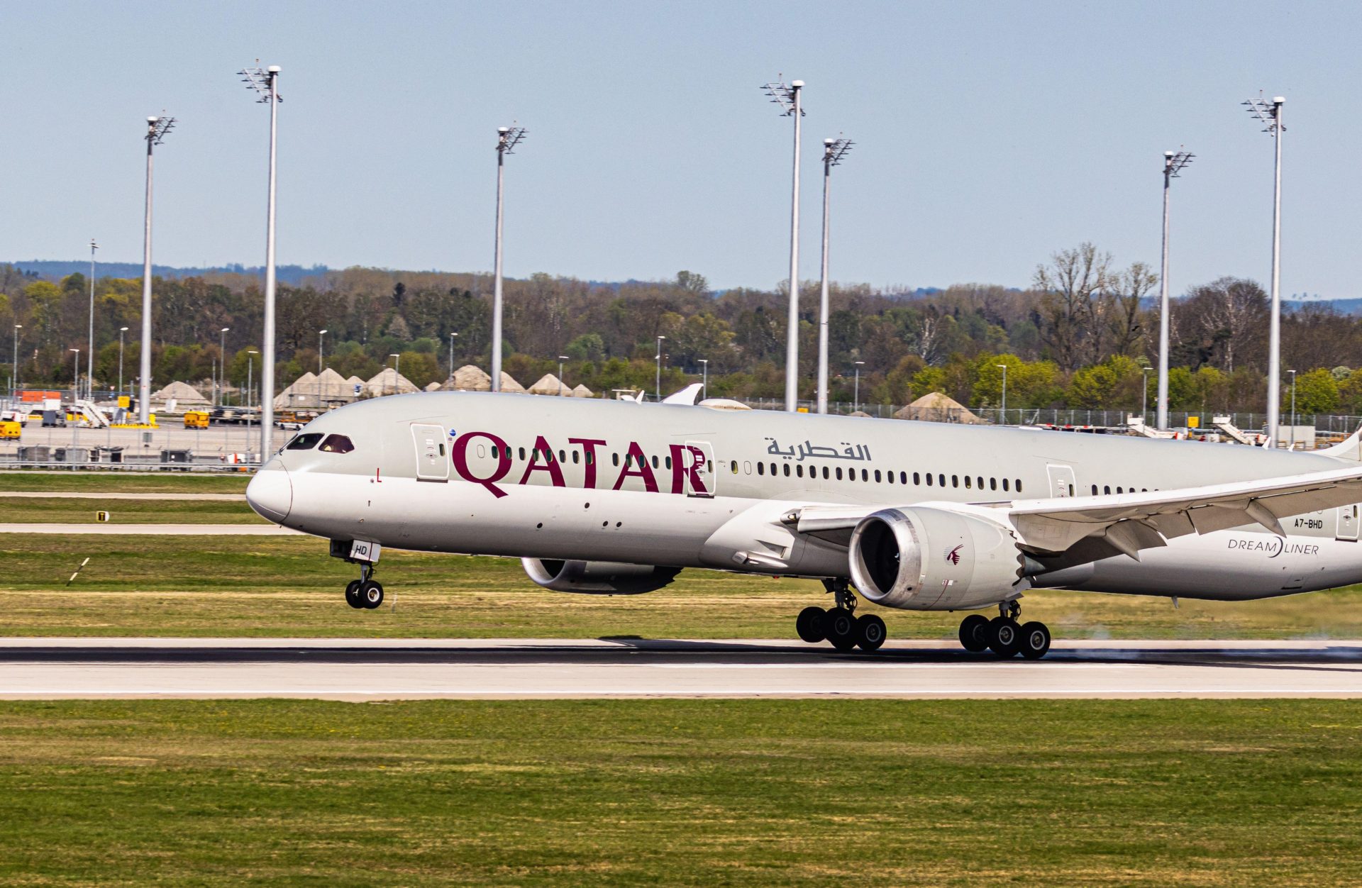 A Qatar Airways Boeing 787-9 Dreamliner lands on a runway, 6-4-24.