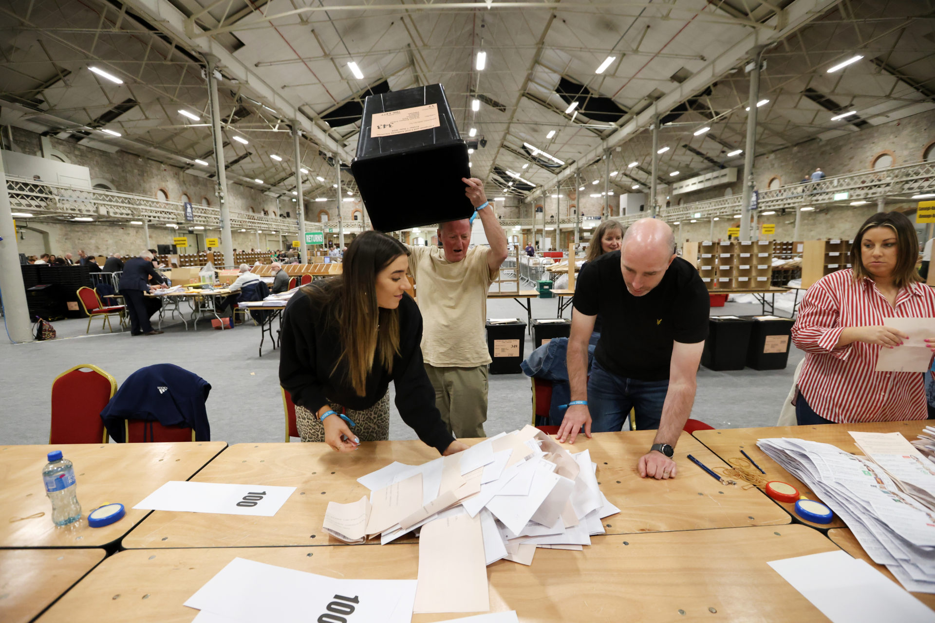 Staff empty ballot boxes for the local and European elections in the RDS in Dublin, 8-5-24.