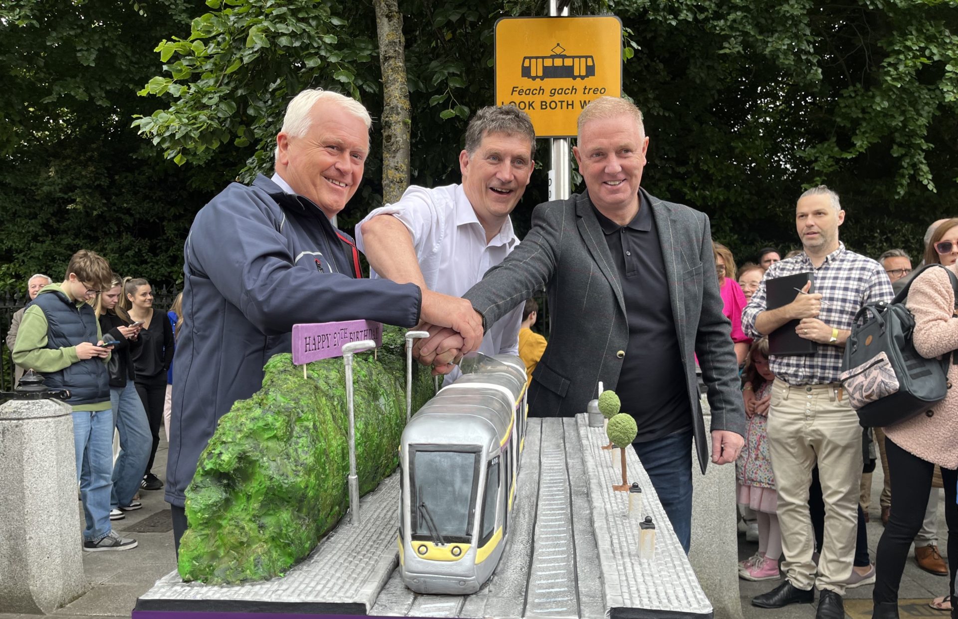 Eamon Ryan cutting a cake at the 20th anniversary of the Luas. Image: Ellen Kenny