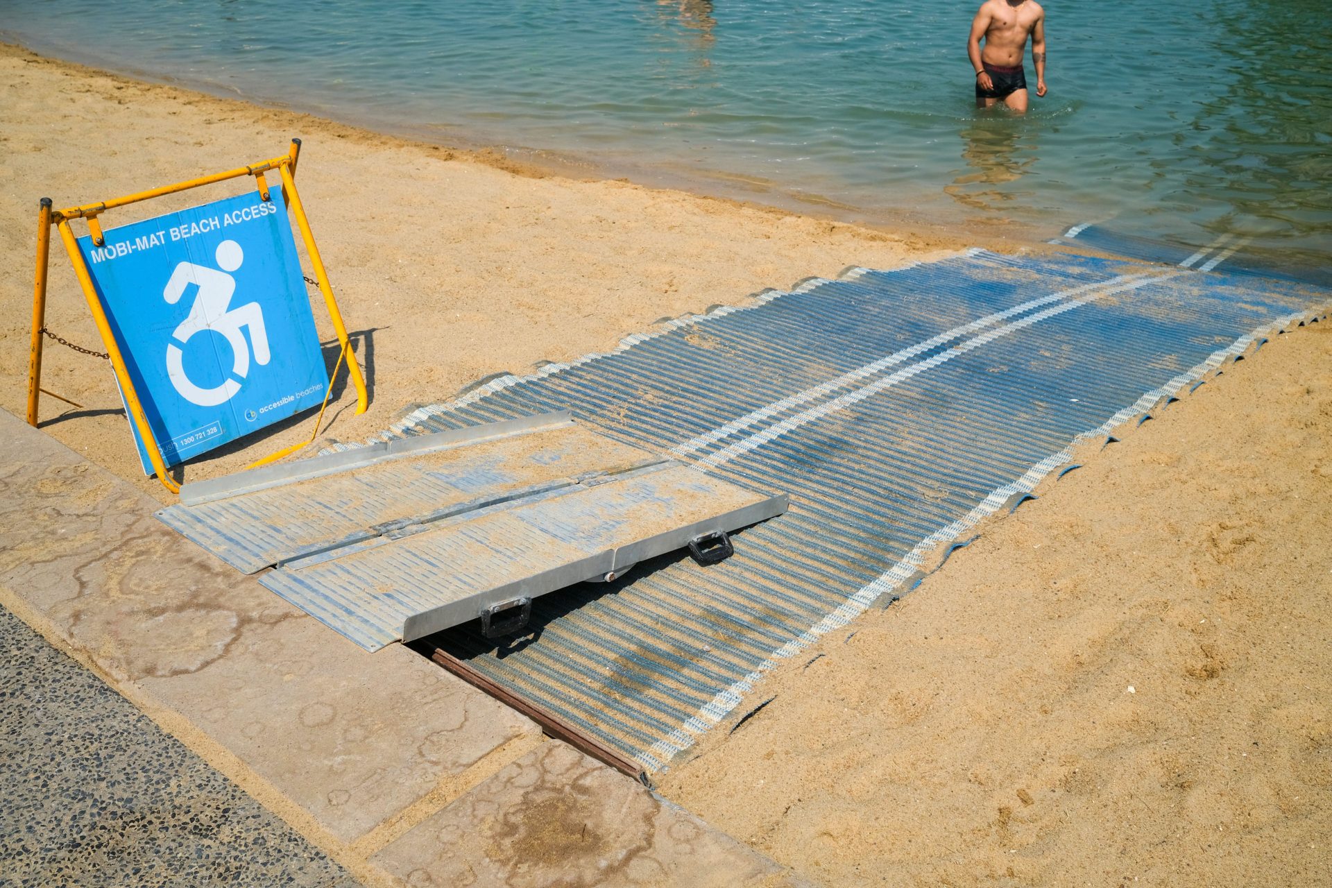 Wheelchair beach mat at the Darwin Waterfront lagoon, Australia. Image: Regis Martin / Alamy Stock Photo 