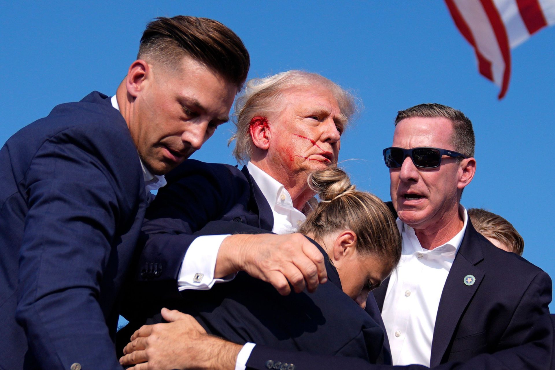 Republican presidential candidate former President Donald Trump surrounded by U.S. Secret Service agents at a campaign rally following an assassination attempt. Image: AP Photo/Evan Vucci