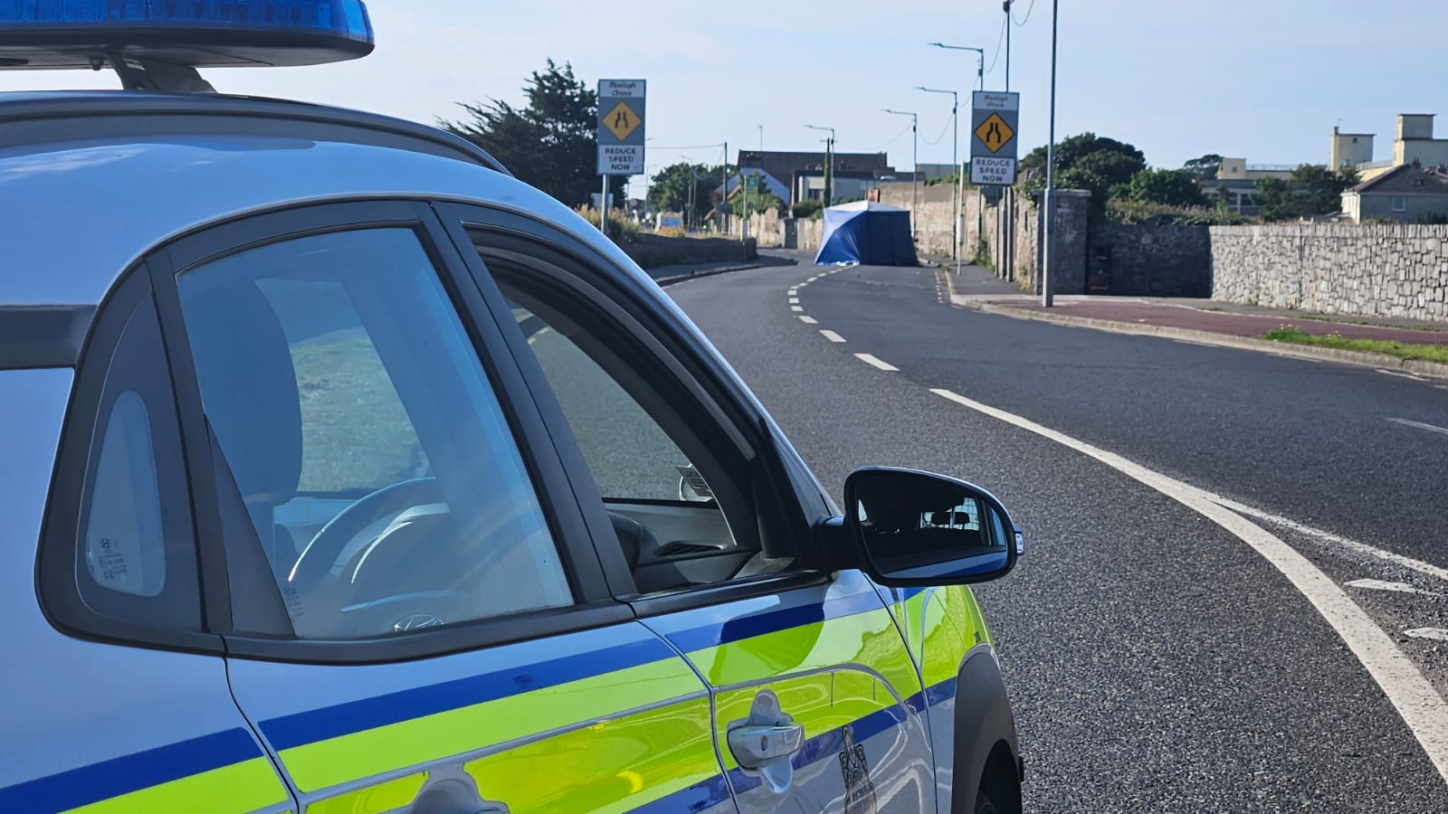 A blue tent is erected around the crash site on the Coast Road in Baldoyle, Dublin