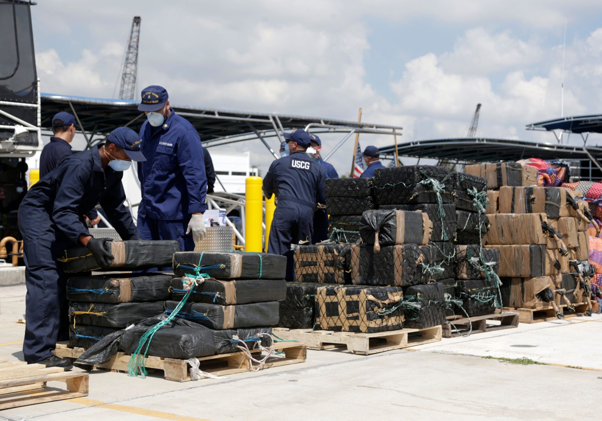 Members of the U.S. Coast Guard offload bails of over eight tons of cocaine interdicted in international waters, from the Cutter Bernard C. Webber at Coast Guard Station Miami Beach, Monday, June 13, 2016, in Miami Beach, Fla. The drugs, with an estimated