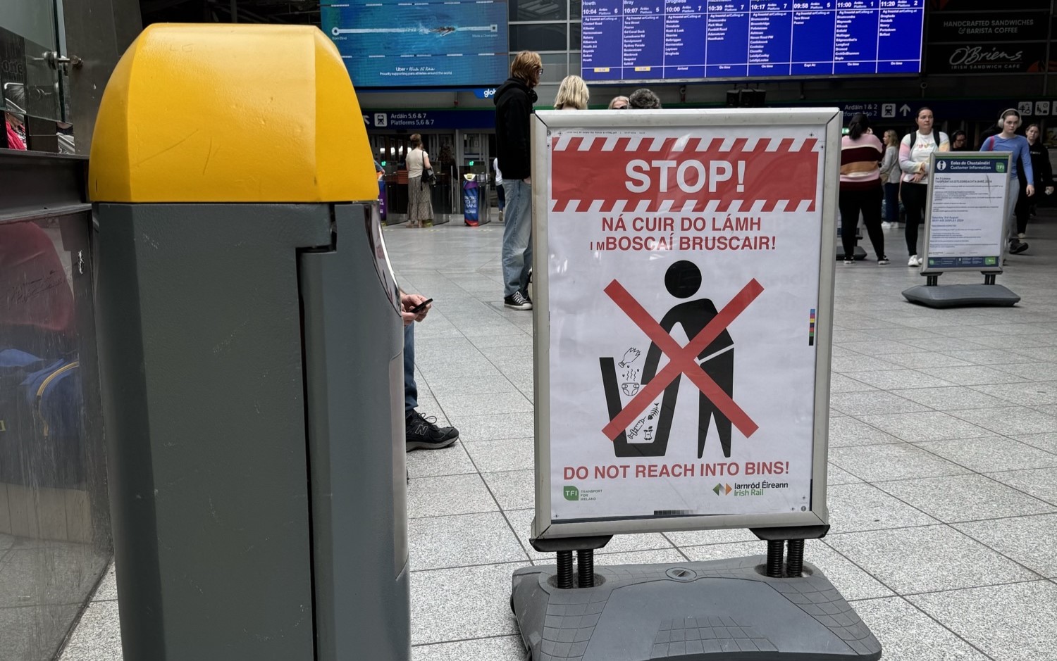 Sign at Heuston Station warning people not to search through bins for Deposit Return Scheme. Image: Barry Kenny