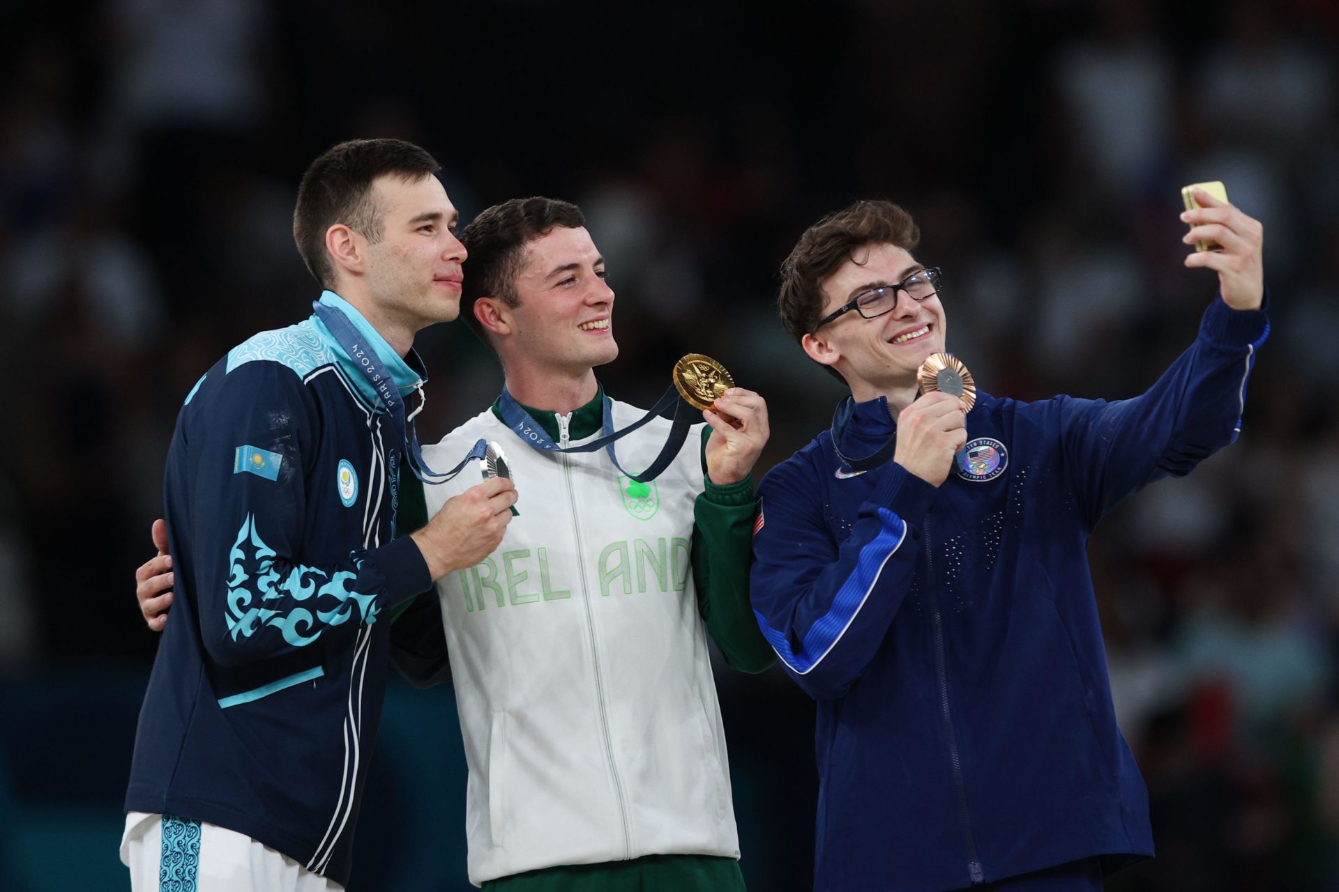  Silver medalist Nariman Kurbanov of Team Kazakhstan, Gold medalist Rhys McClenaghan of Team Ireland, and Bronze medalist Stephen Nedoroscik of Team United States pose for a selfie. Image: Craig Mercer / Alamy Stock Photo 