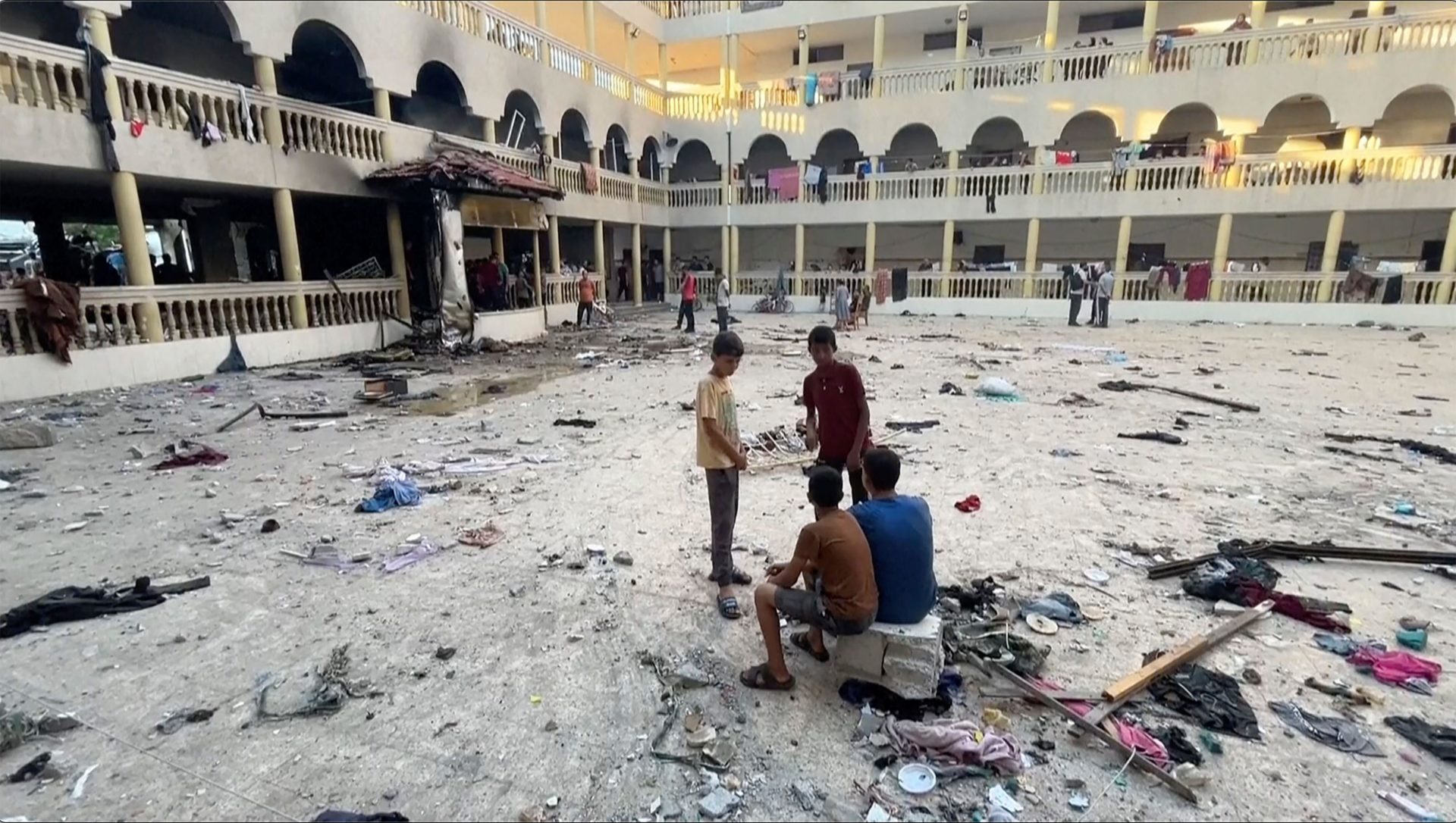 People inspect the rubble at a school after being hit by an Israeli airstrike in Gaza City. Image: Associated Press / Alamy Stock Photo