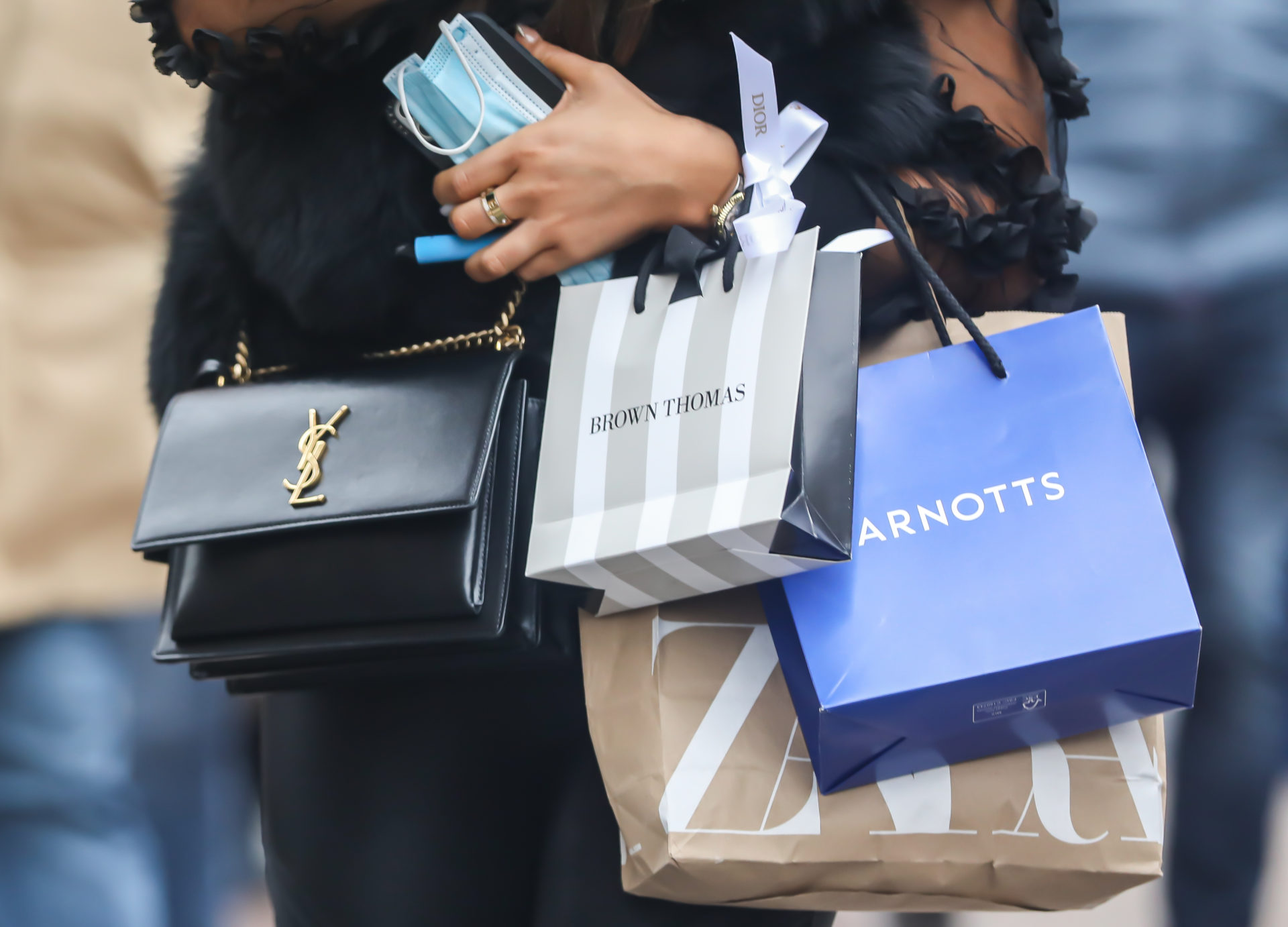 A shopper carries Brown Thomas and Arnotts bags, 24-12-21. 