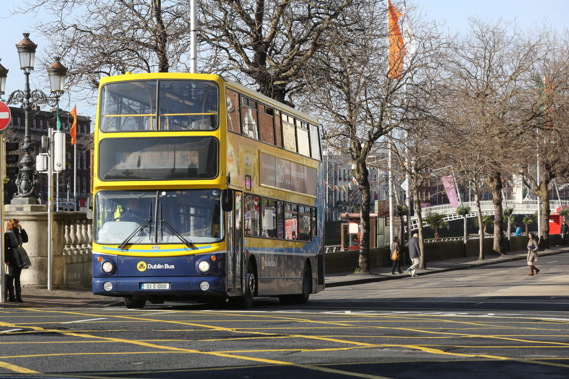 Dublin bus travels through the city centre on a bright day in Ireland. Image: reallifephotos / Alamy Stock Photo