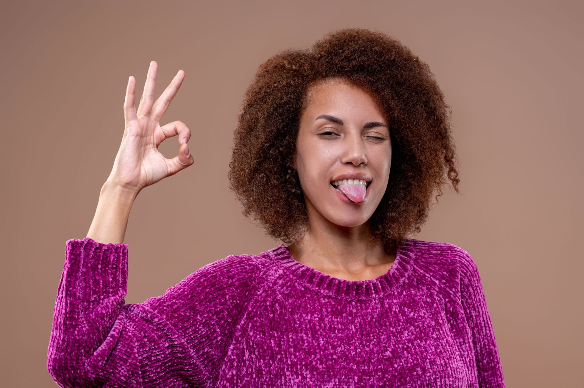 A woman with her tongue out.