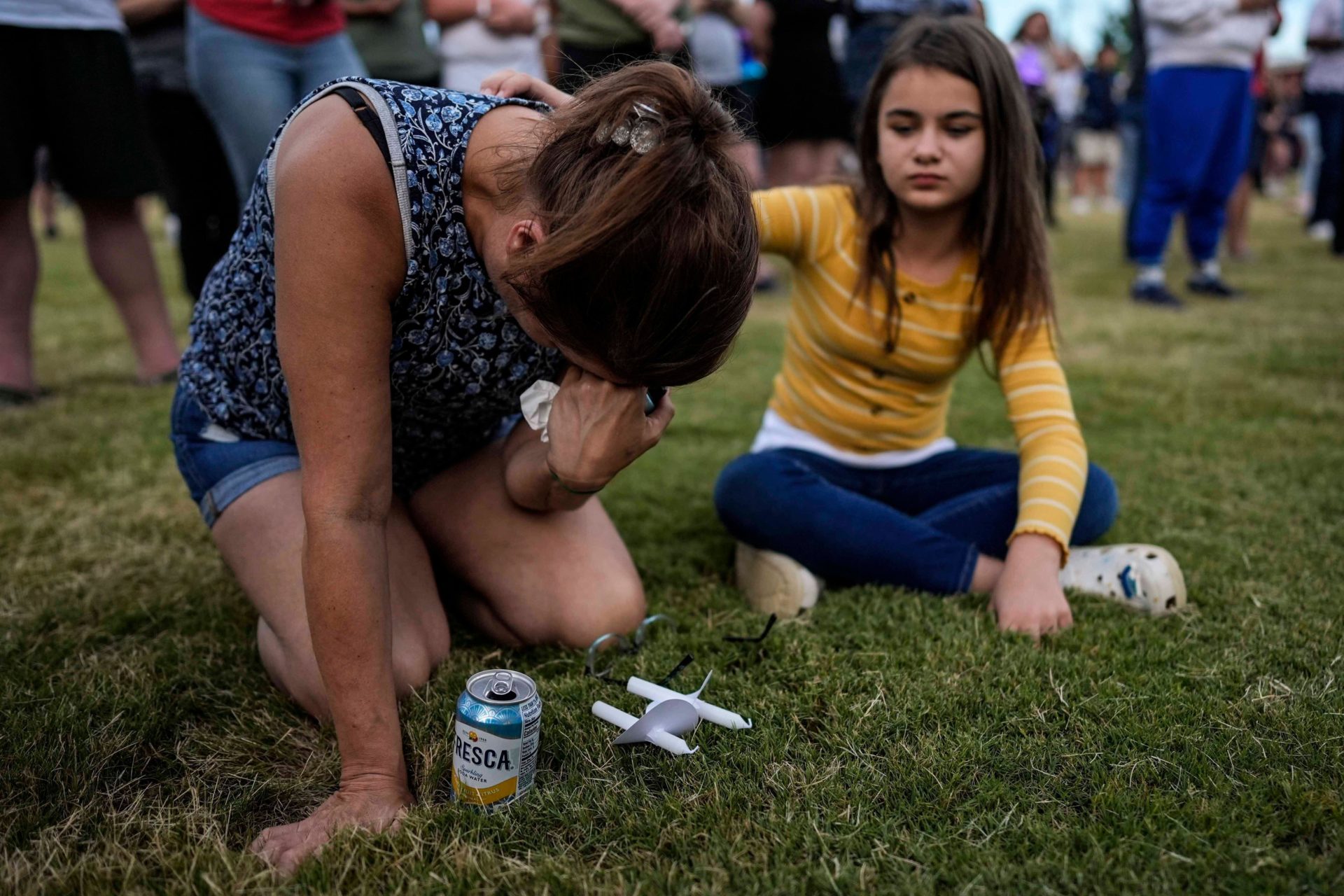 Brandy Rickaba and her daughter Emilie pray during a candlelight vigil for students and teachers at Apalachee High School, 4-9-24.