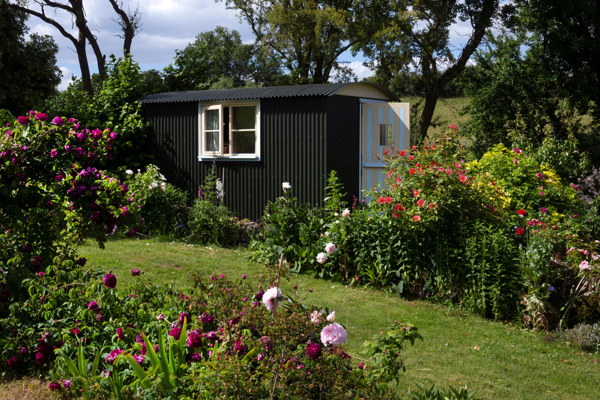 A shepherd's hut in a garden. 