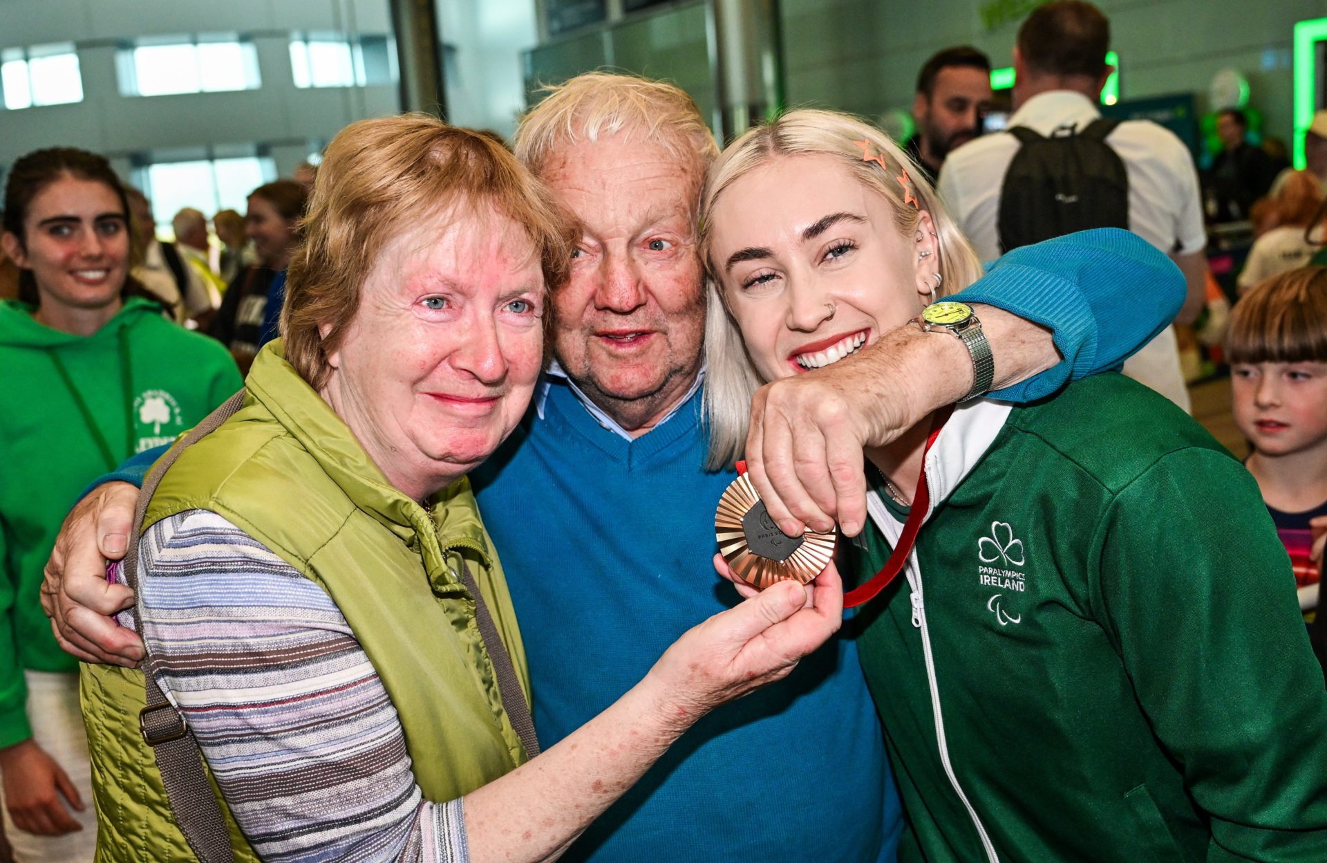 Paralympics Ireland athlete Orla Comerford with her grand-uncle Eamonn and grand-aunt Loretta on arrival into Dublin Airport, 9-9-25.