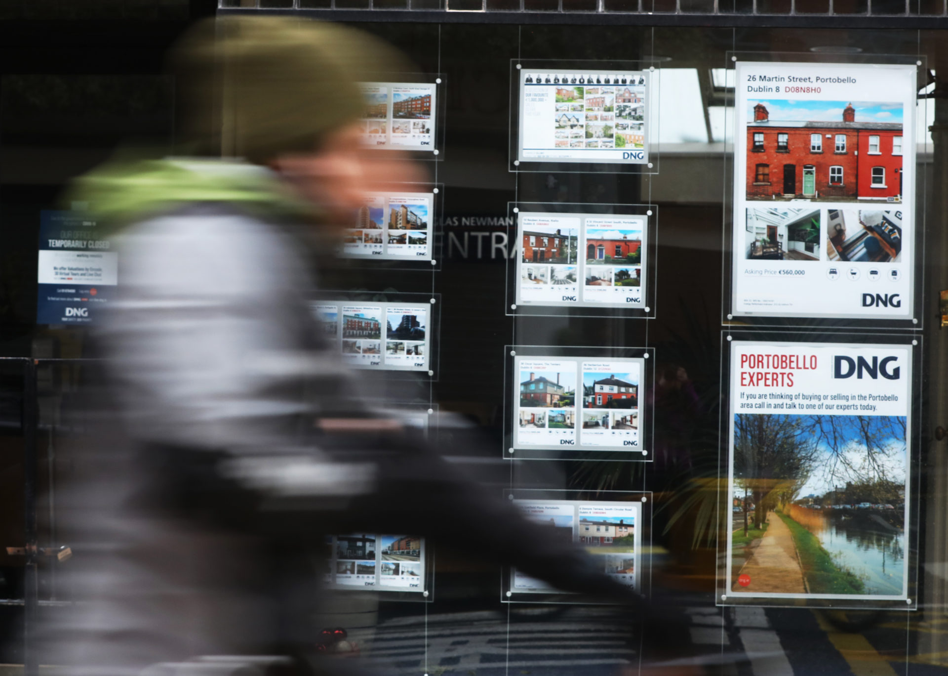 Members of the public passing images of houses for sale in DNG in Dublin, 29-1-21