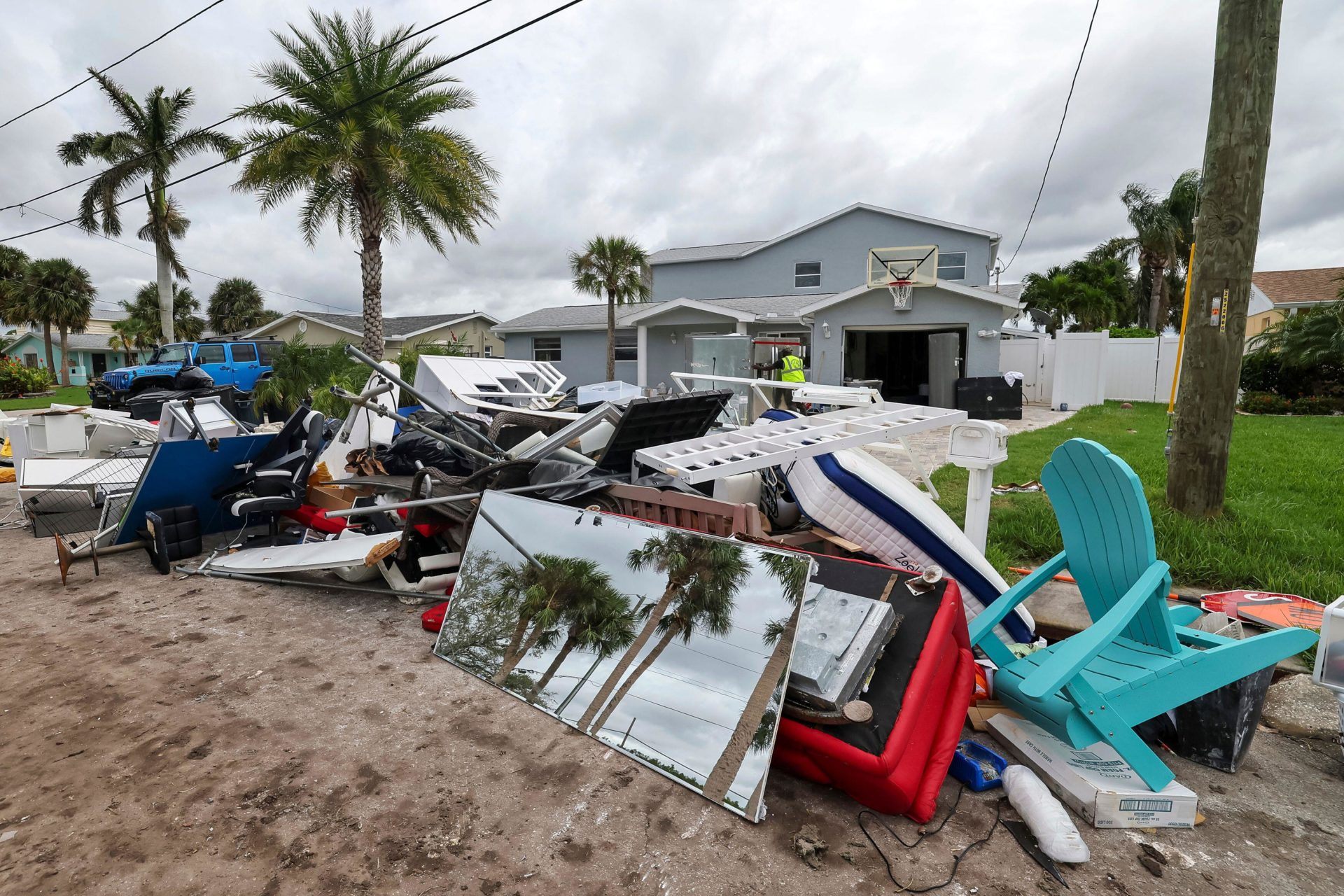 Contractors clean debris left by Hurricane Helene in preparation for Hurricane Milton