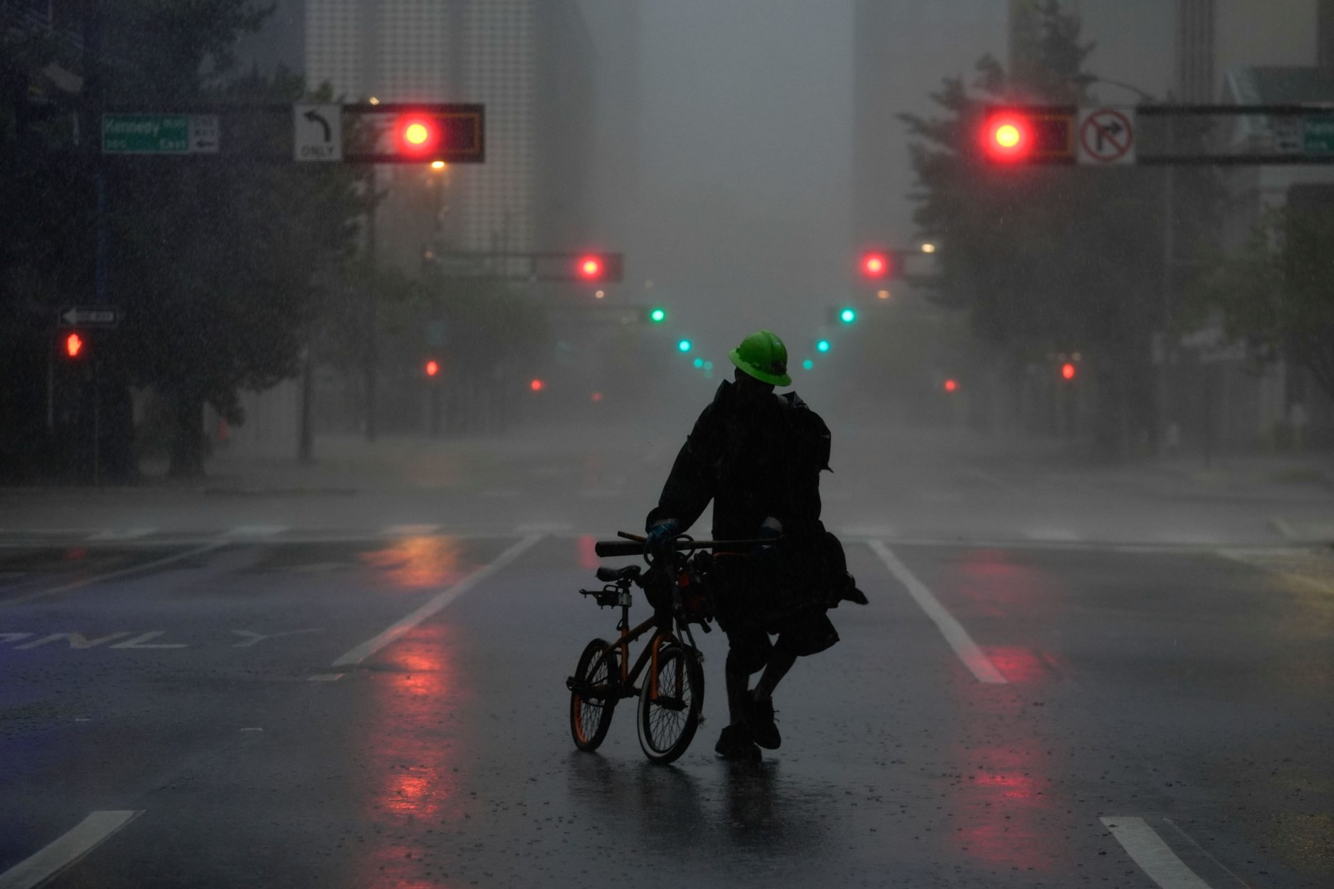 Ron Rook, who said he was looking for people in need of help or debris to clear, walks through windy and rainy conditions on a deserted street in downtown Tampa, Florida