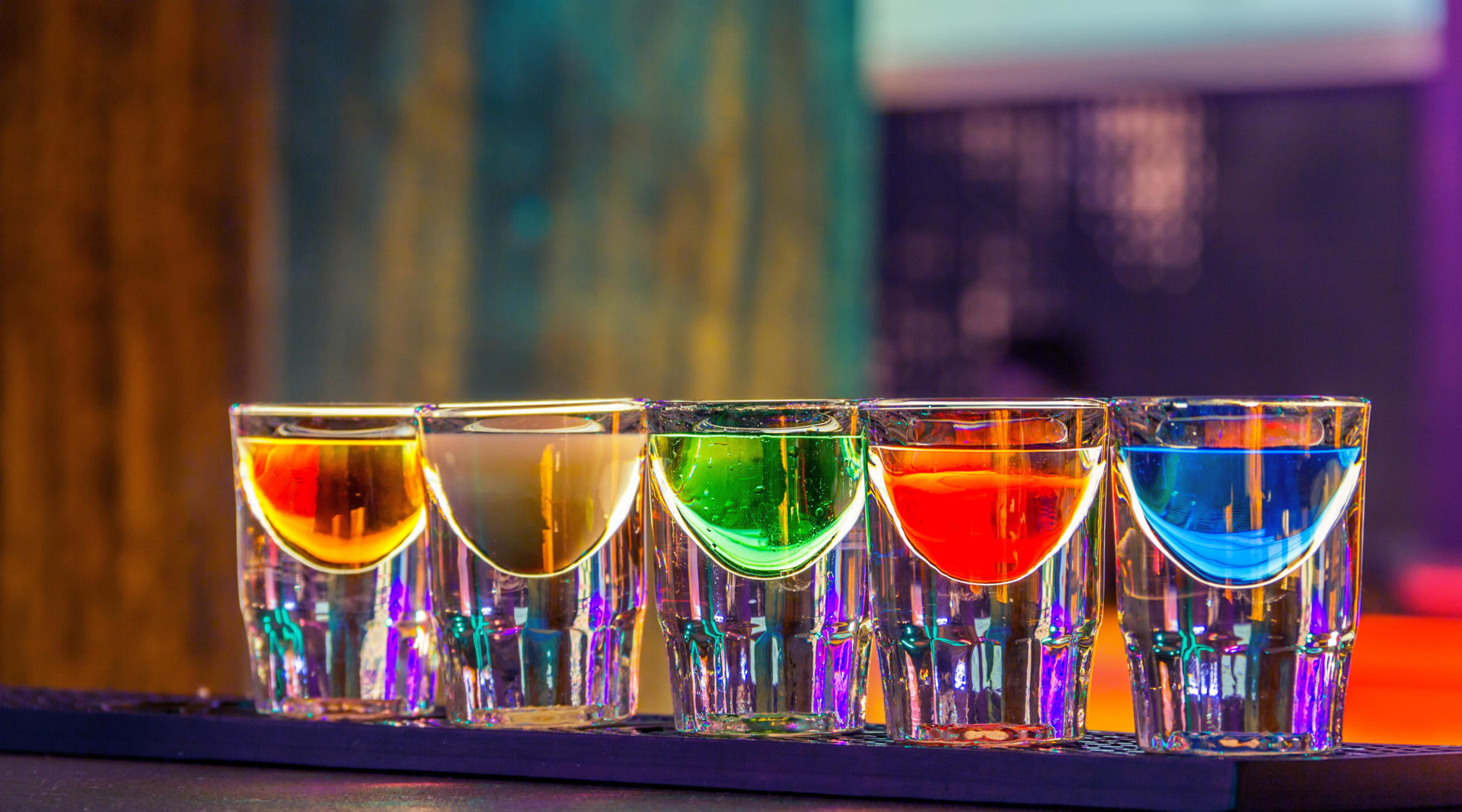 Colorful shot drinks in bar in night