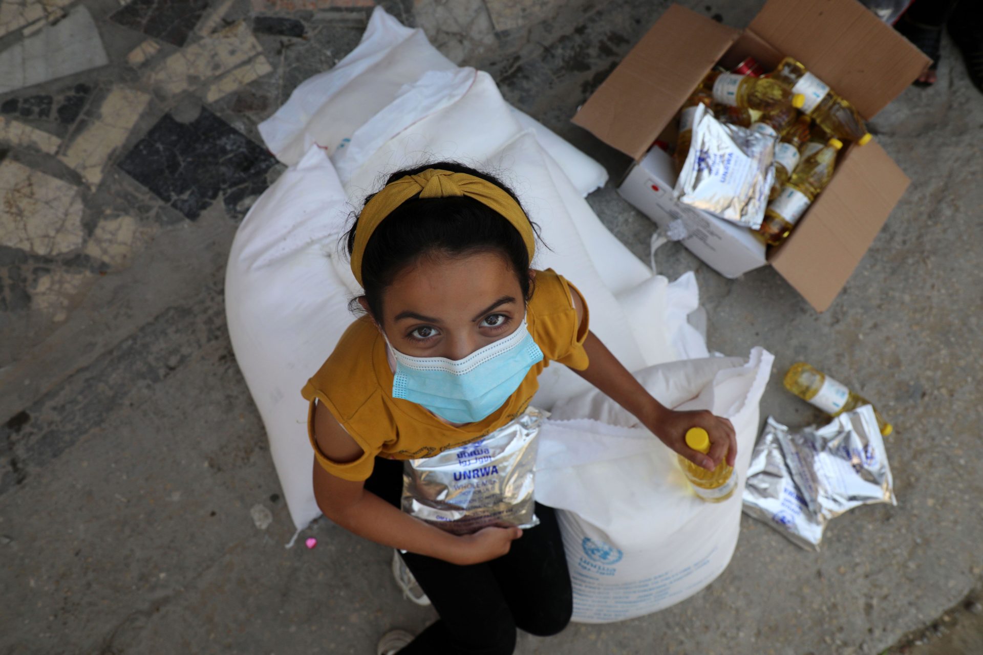 Palestinian Children receive UNRWA food aid in Gaza City