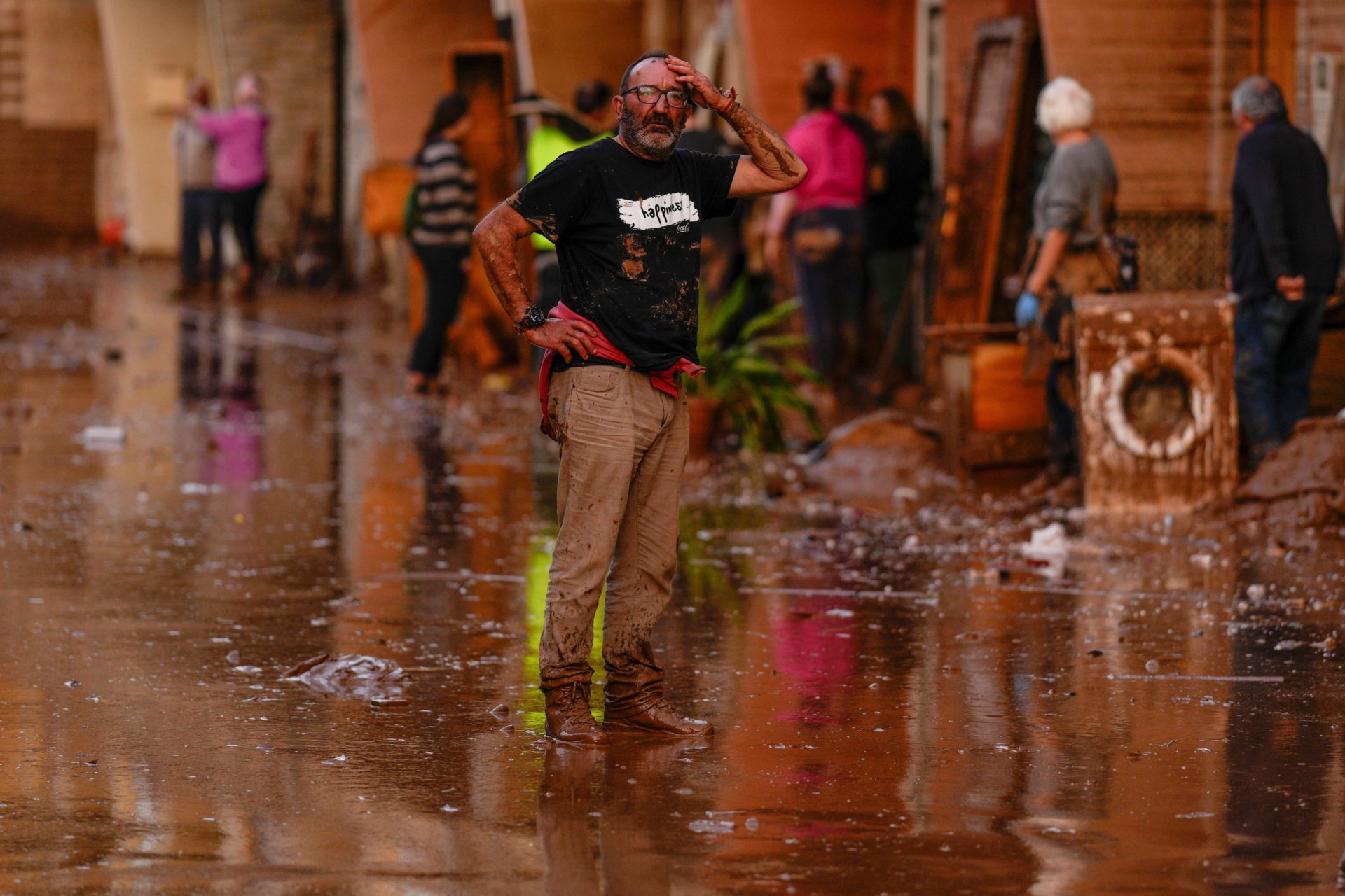 A man reacts in front of houses affected by floods in Utiel, Spain