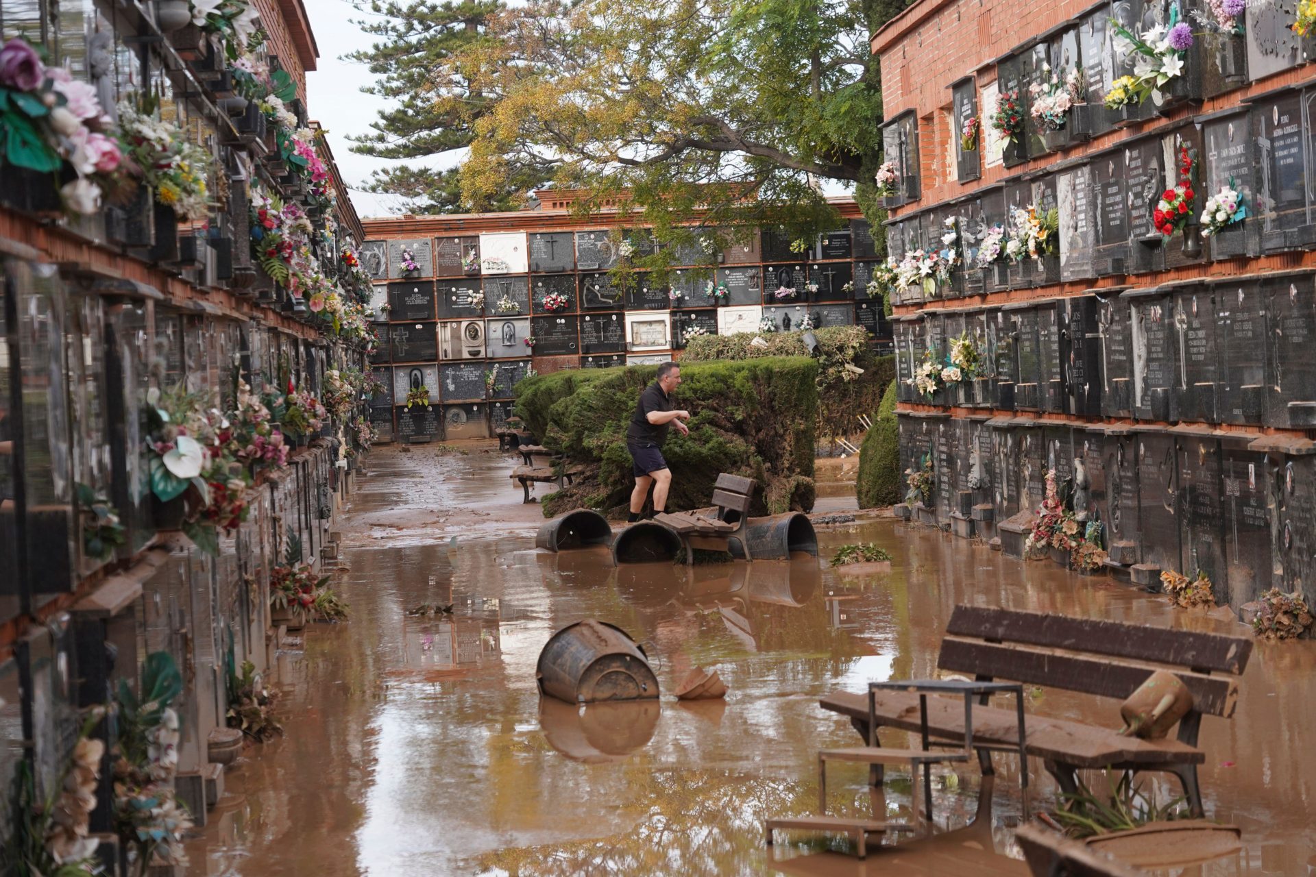 A man walks inside a flood damaged cemetery on the outskirts of Valencia, Spain, Friday, Nov. 1, 2024 after flooding in the region. Image: Associated Press / Alamy Stock Photo