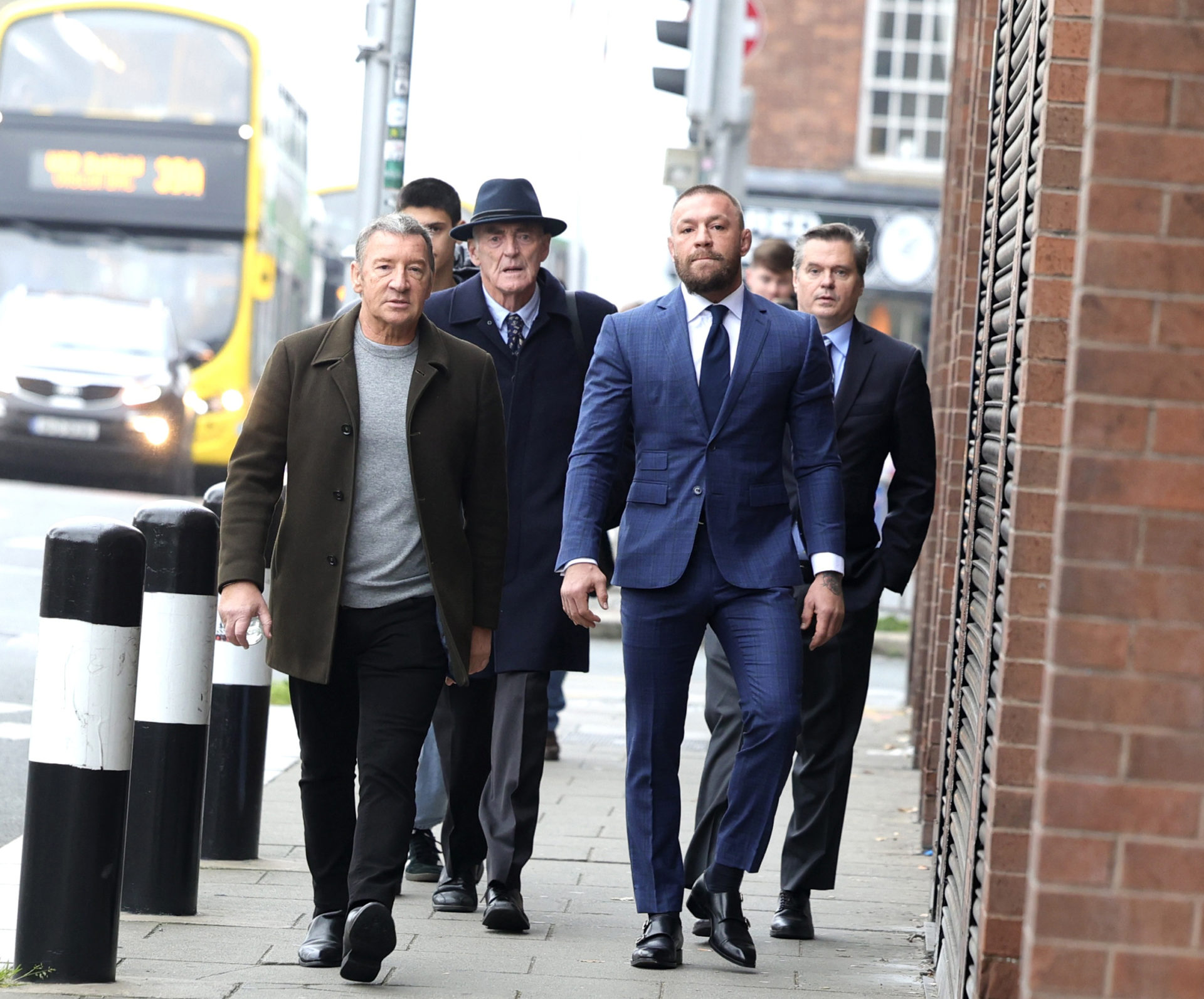 Conor McGregor arrives at the High Court with his father Tony (L) and solicitor Michael Staines (Hat)