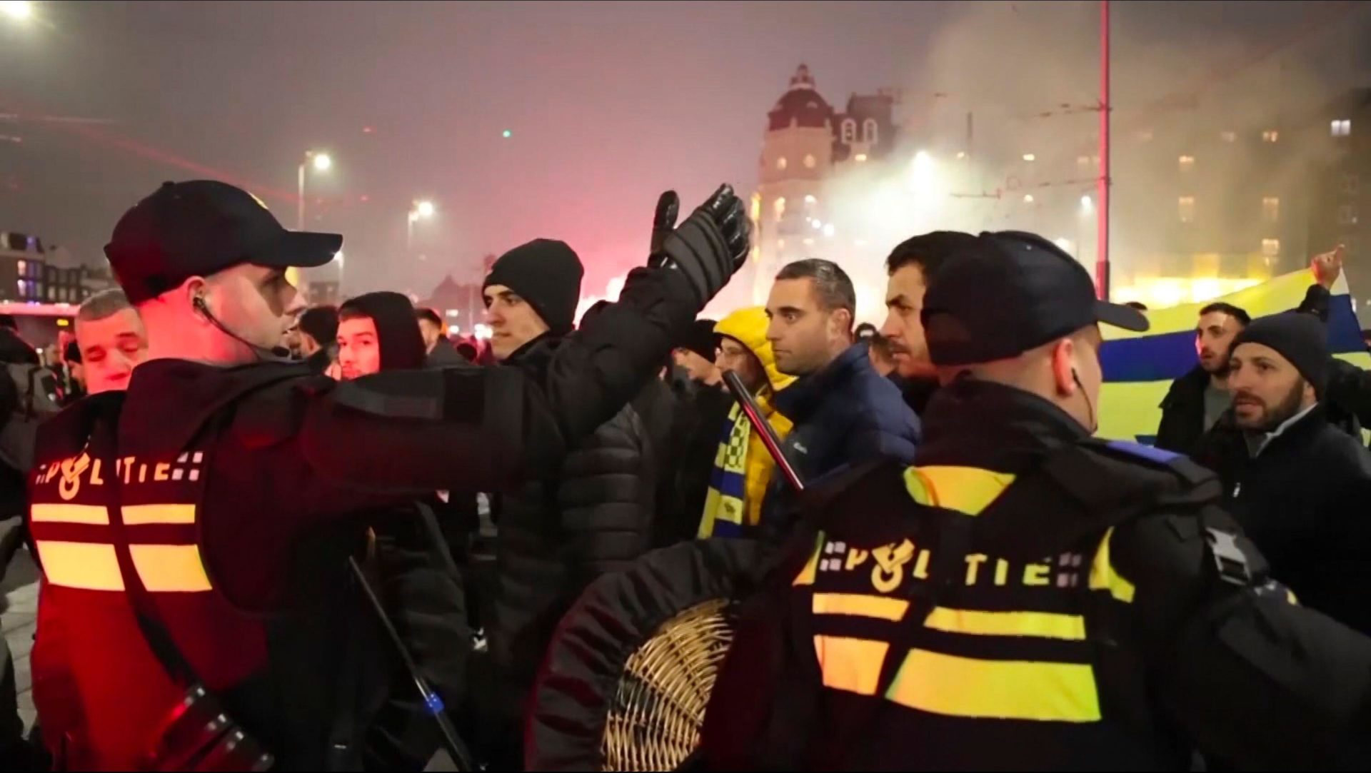 Policeescort Maccabi Tel Aviv supporters to the metro station leading them to the Ajax stadium, after pro-Palestinian supporters marched near the stadium, in Amsterdam