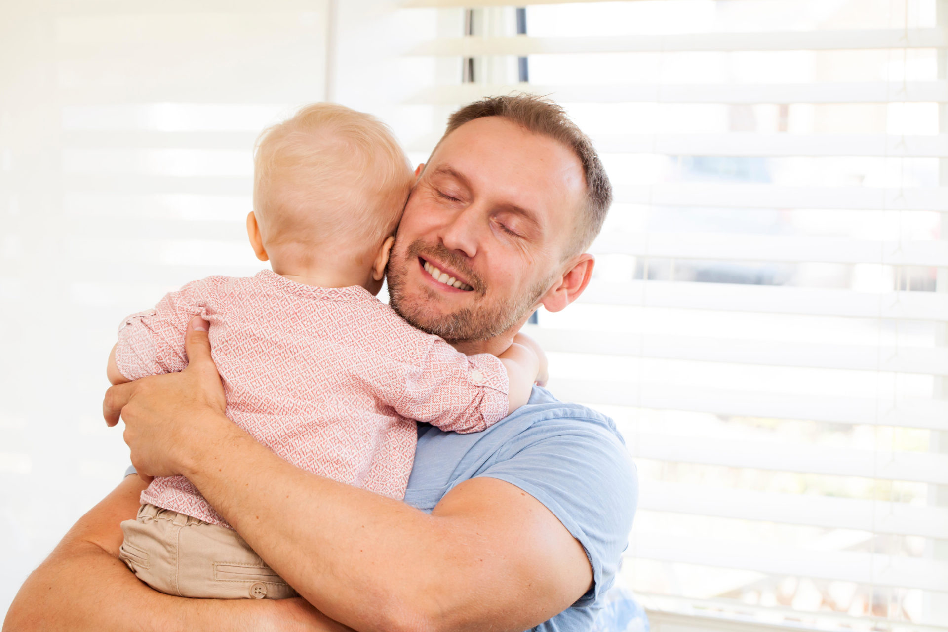 Dad holding his one year old baby son