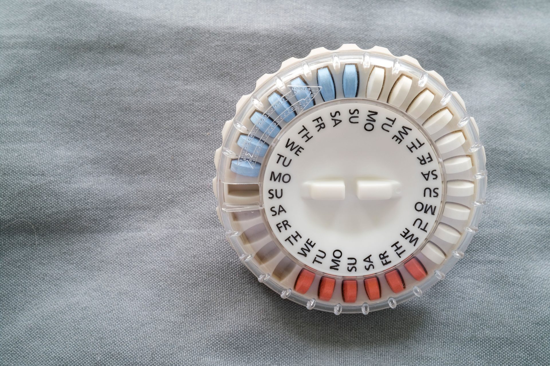 An already open HRT, Hormone Therapy Replacement pills in dispenser for perimenopause treatment.