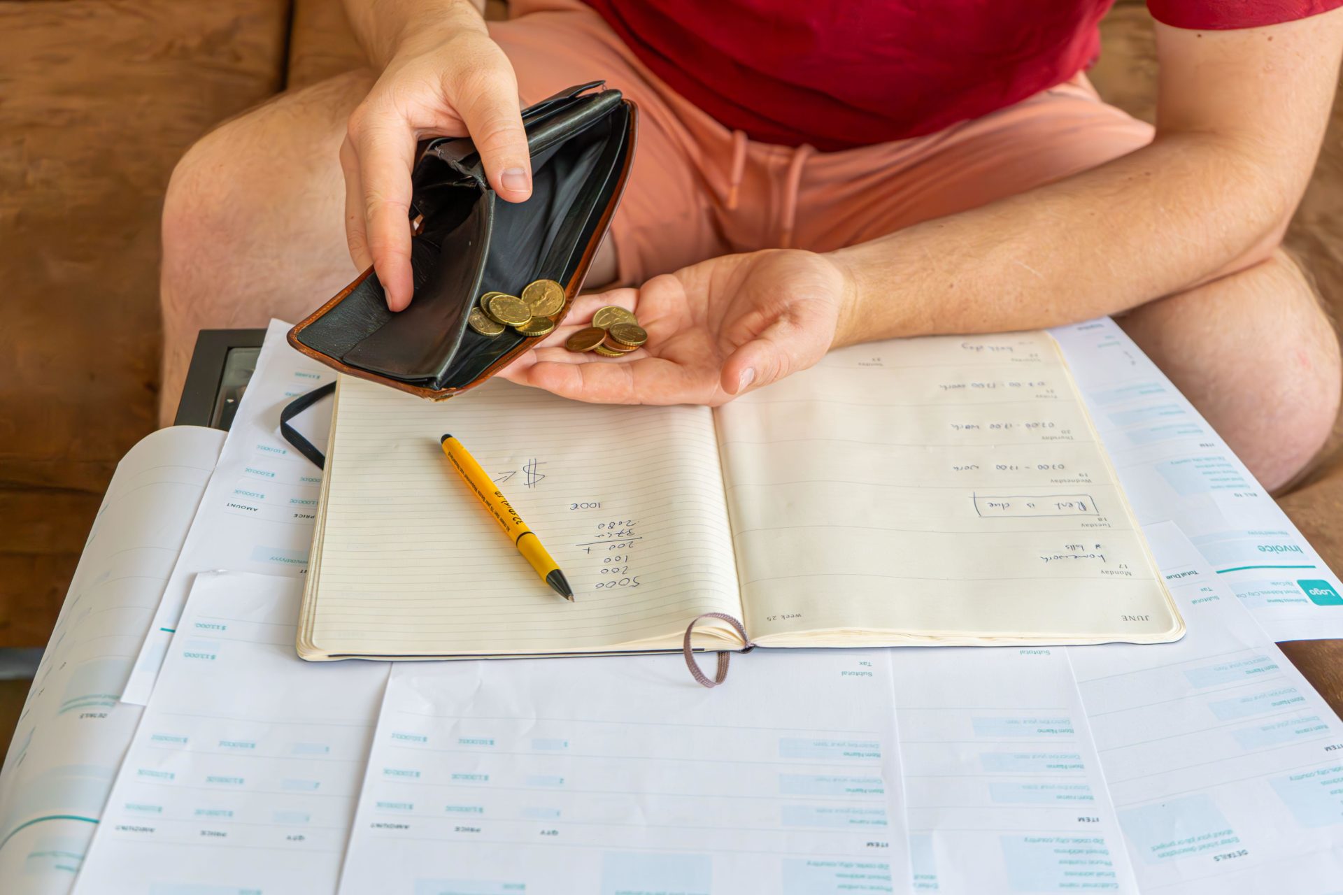 Man with many bills or invoices and no money. Shortage, Bankruptcy, doing taxes, barely any money in his wallet.