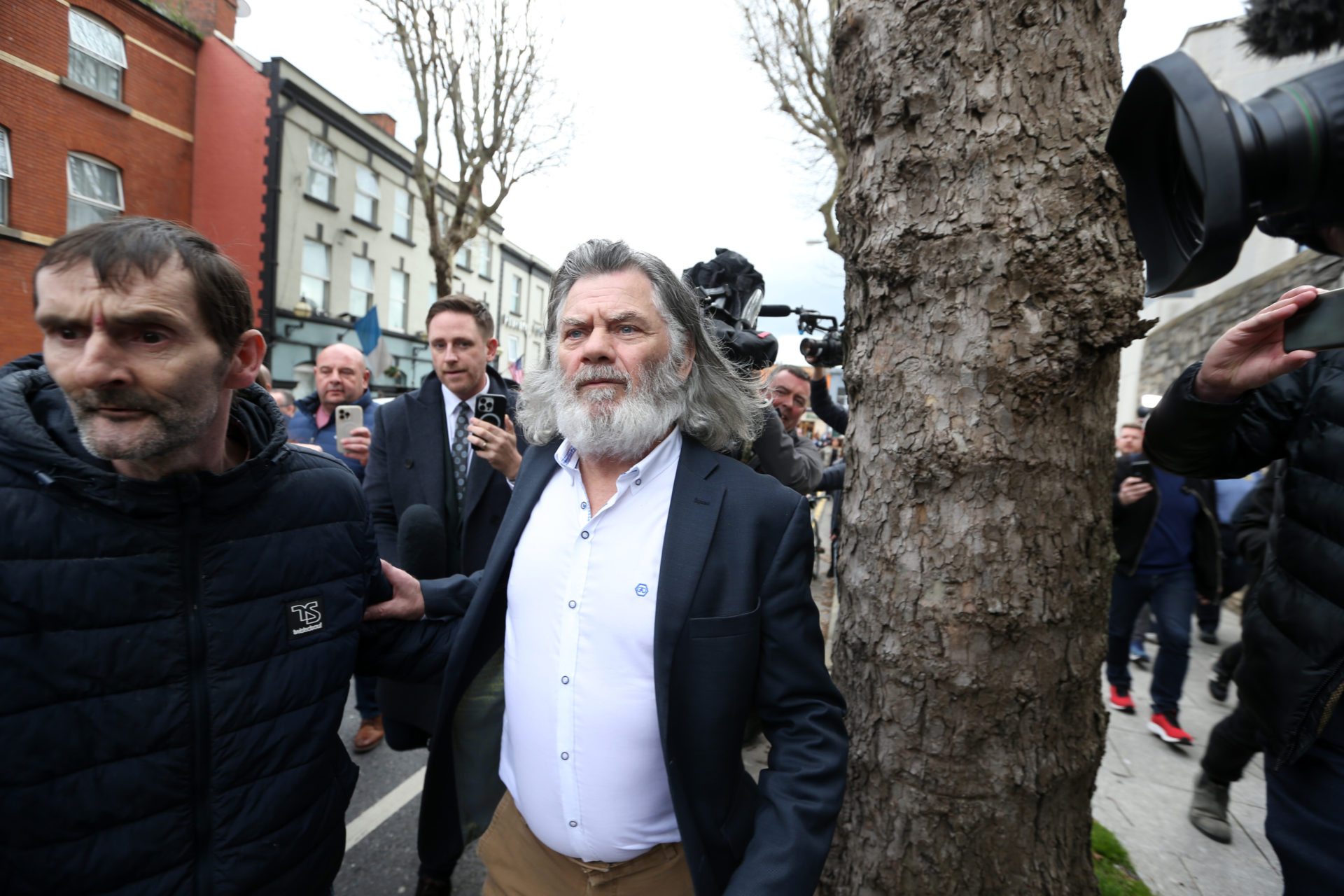 Pictured is Gerry The Monk Hutch being followed by the media and reporters after being freed following his court case at the Criminal Courts.