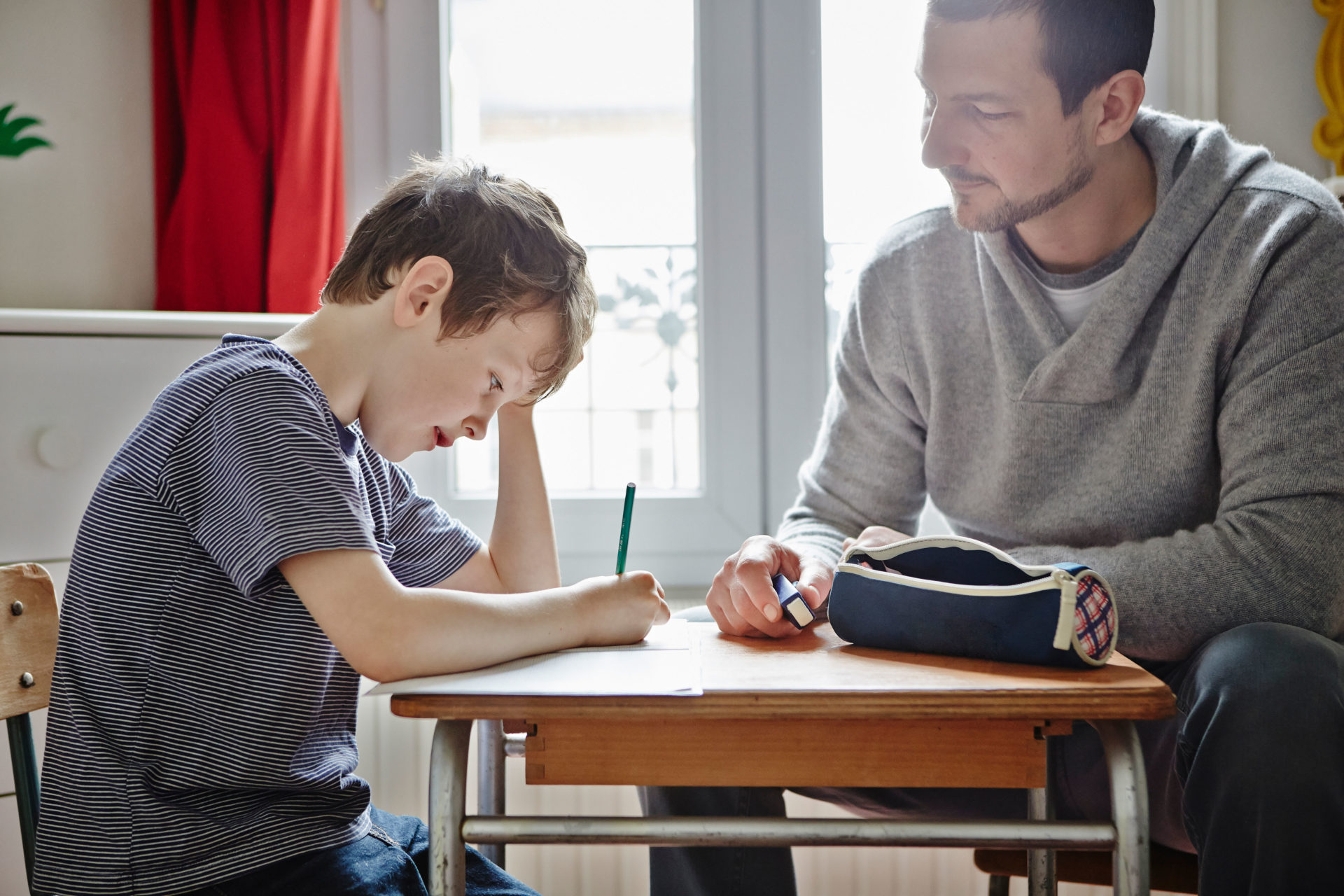 A father helping his son with homework