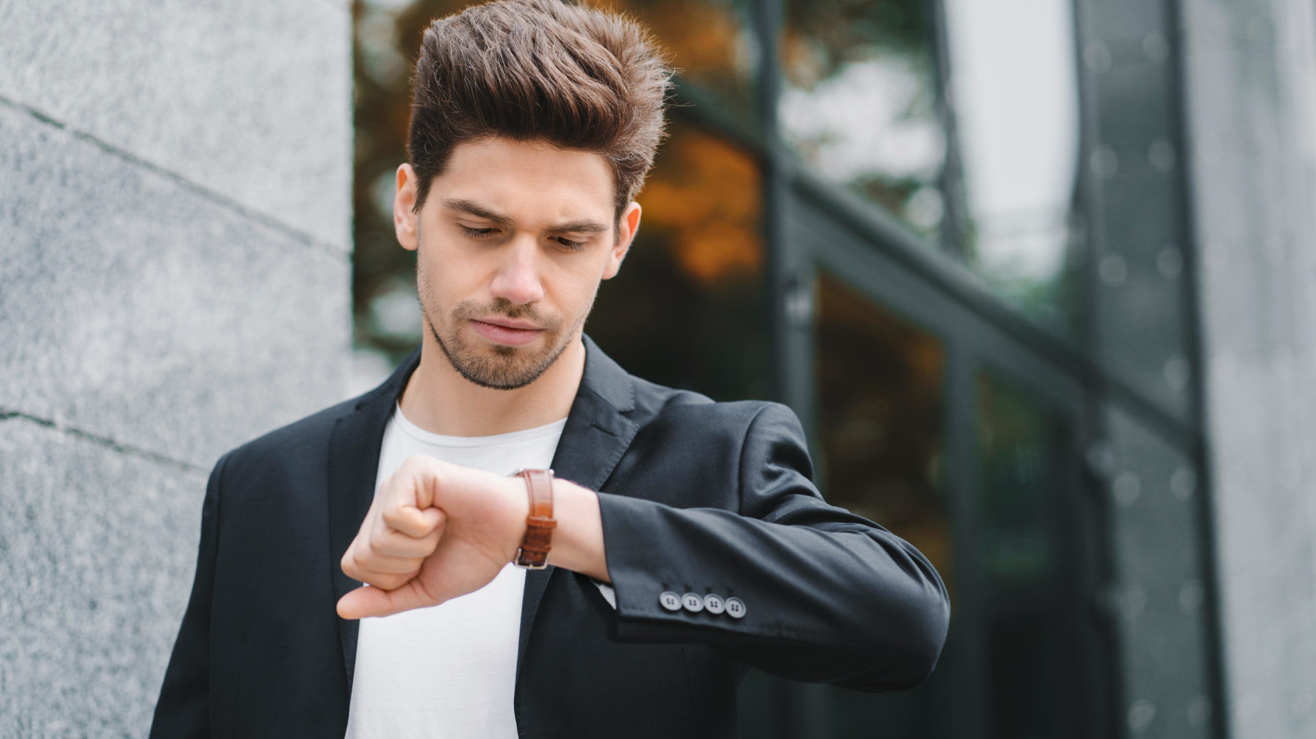Young man looks at his watch