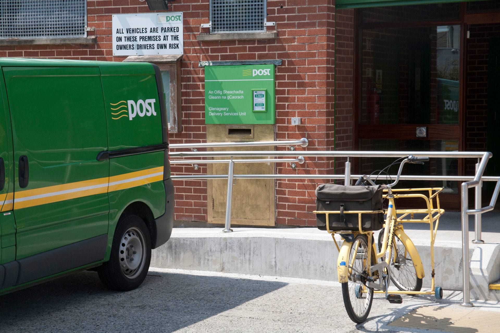 Delivery van and bicycle outside Glenageary An Post sorting office in Dublin Ireland. Image: Alamy