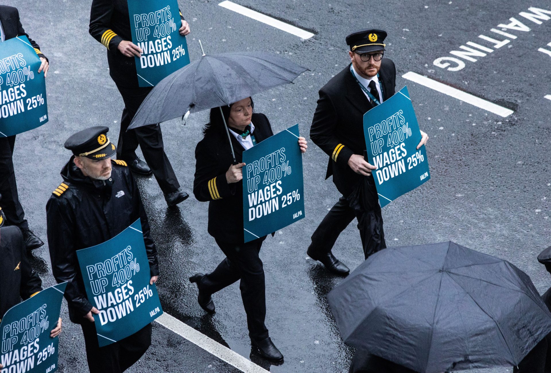 Aer Lingus pilots march around Dublin Airport as they begin their eight-hour strike on Saturday in a bitter dispute with the airline over pay. 