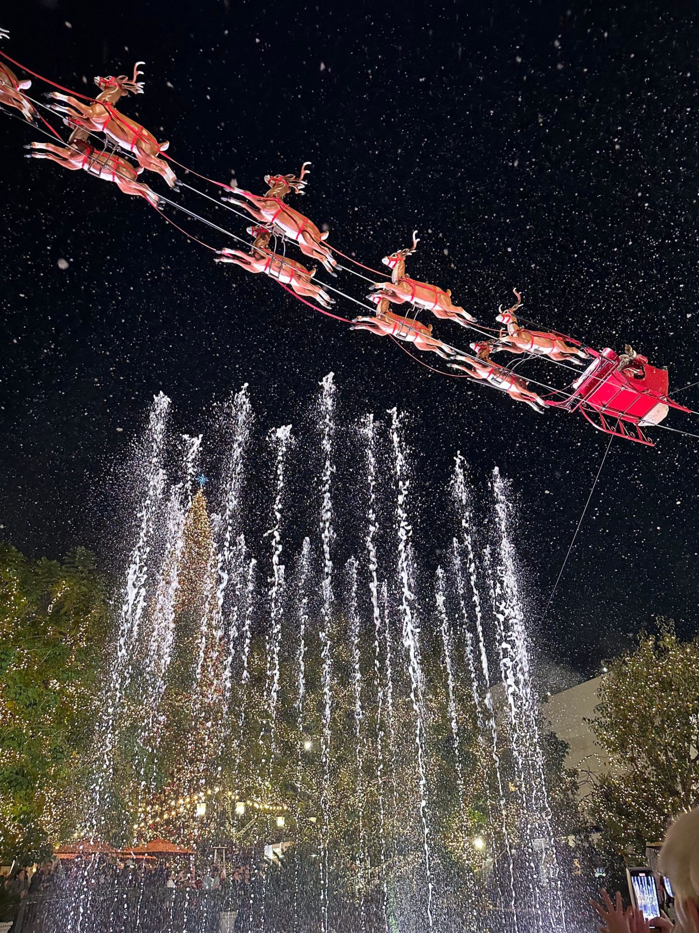 Santa Claus flying through the sky in his sleigh